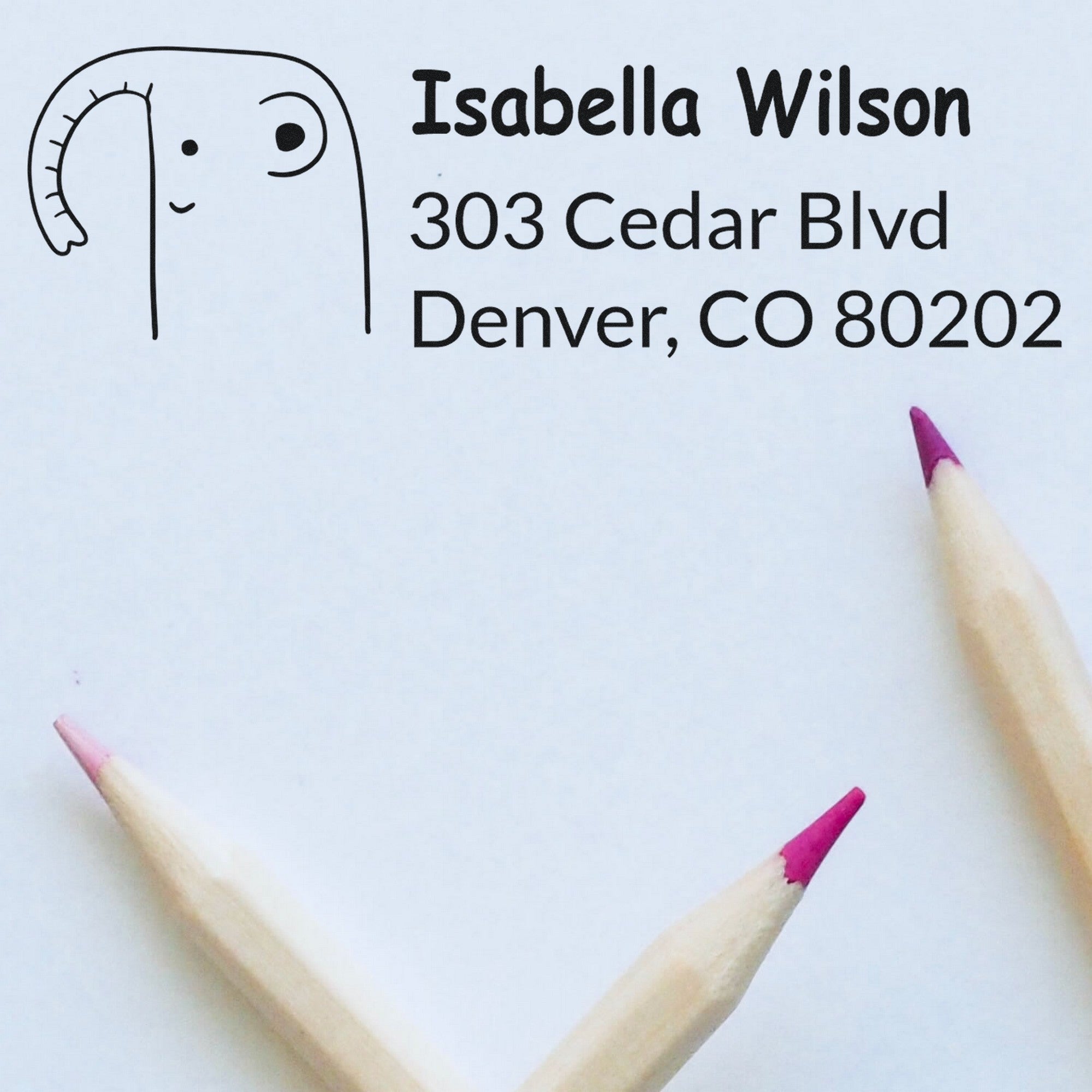 Endearing Elephant Customize Mail Address Self-Inking Stamp featuring a cute elephant design and the text "Isabella Wilson, 303 Cedar Blvd, Denver, CO 80202." This Personalizable Return Mail Stamper is shown on a white background with colored pencils.