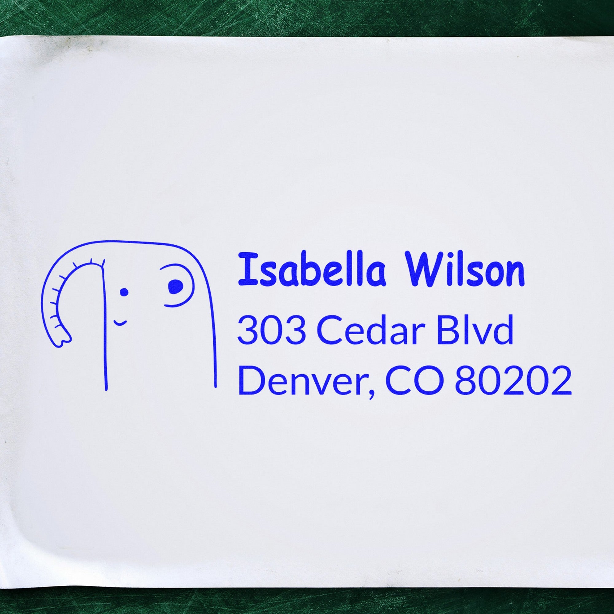 Endearing elephant design on a custom-made home stamper with a wood handle. Personalized home address rubber stamp featuring the name Isabella Wilson and address in blue ink on white paper.