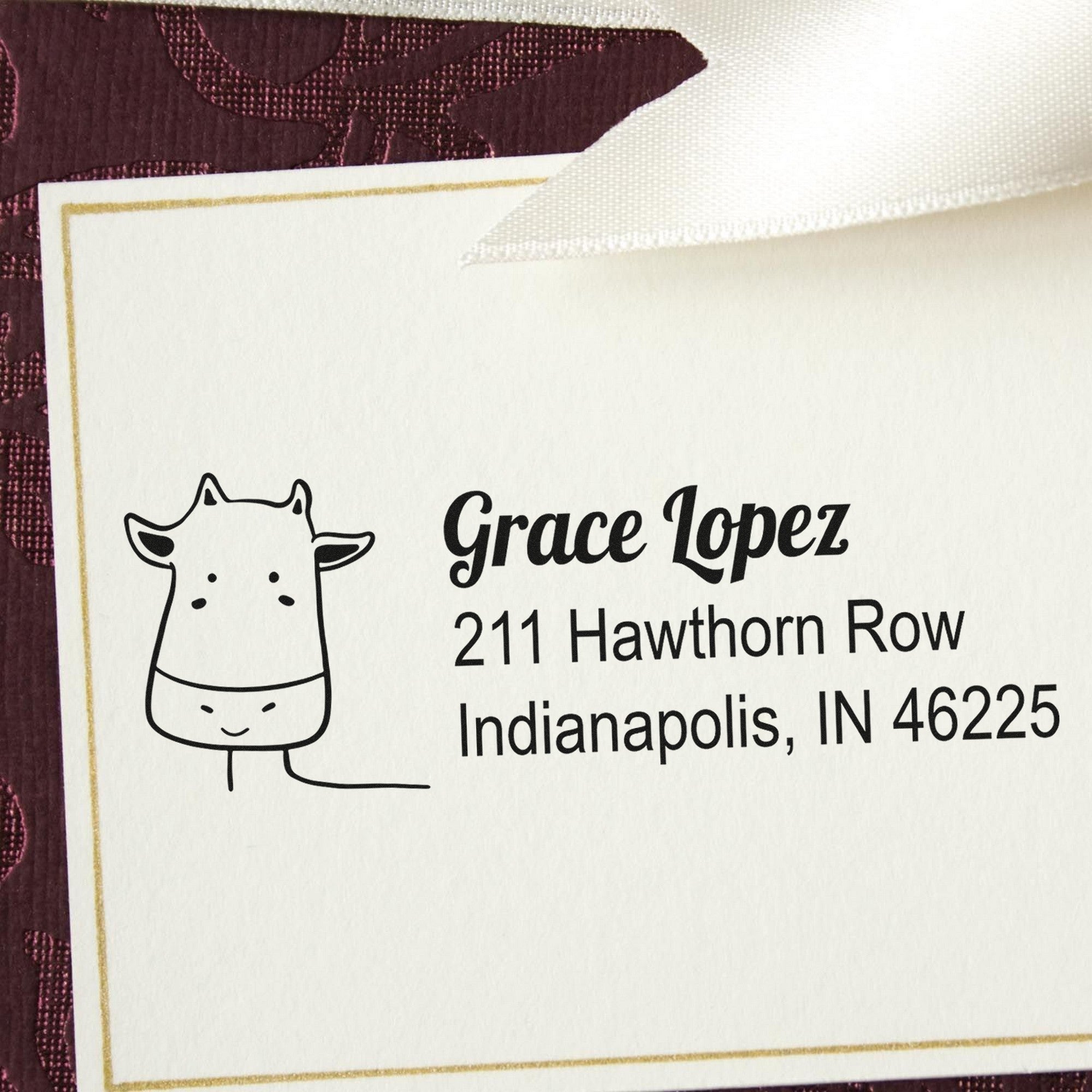 Cow Cuddles Customizable Mail Self-Inking Stamp featuring a cute cow illustration and personalized address stamper with the name Grace Lopez, 211 Hawthorn Row, Indianapolis, IN 46225, on a decorative card with a ribbon.