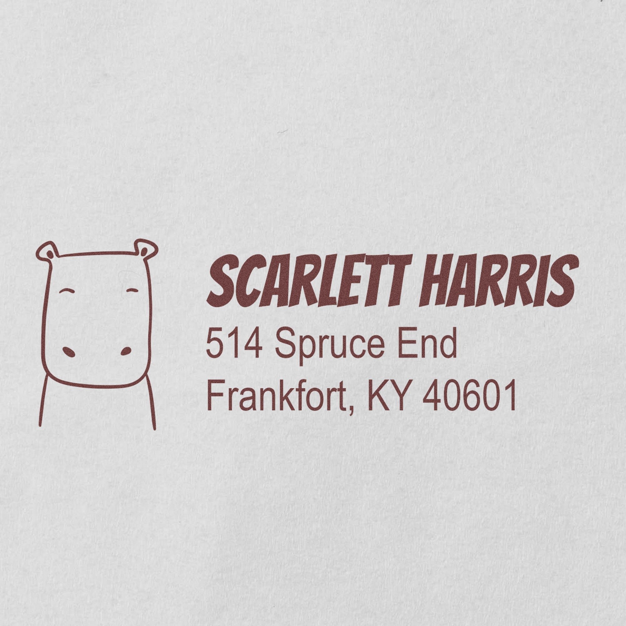 PSI Hopeful Hippo Handmade Home Address For Envelopes Pre-Inked Stamp featuring a hippo illustration and personalized mailing stamper with the name Scarlett Harris and address 514 Spruce End, Frankfort, KY 40601 in brown ink.