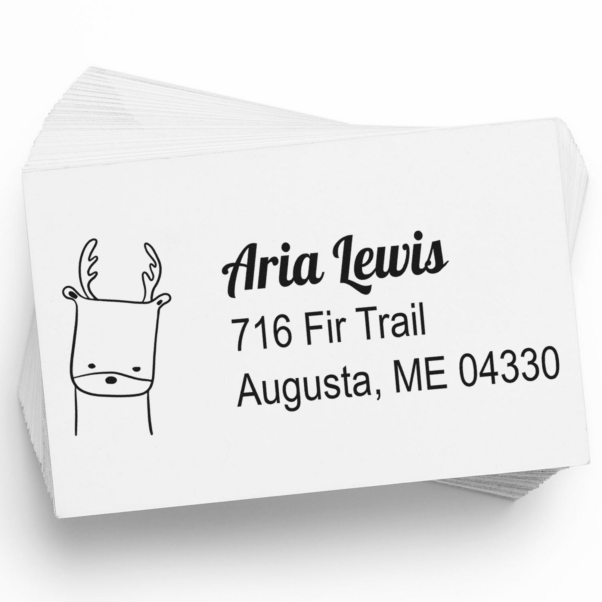 PSI Darling Deer Customize Address Pre-Inked Stamp on a stack of cards, featuring a deer illustration and the text "Aria Lewis, 716 Fir Trail, Augusta, ME 04330." Personalizable New Address Stamper for custom mailing needs.