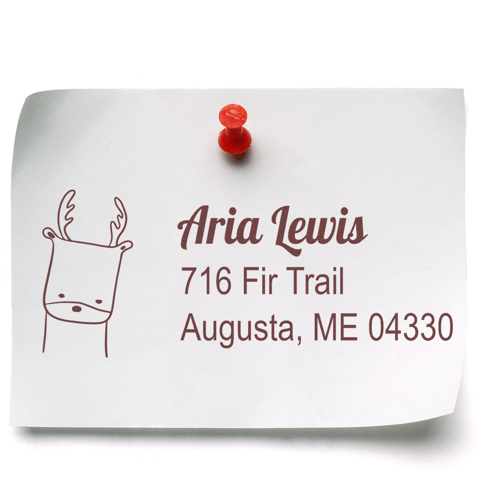 Wood Handle Darling Deer Custom Address Return Rubber Stamp on a white paper pinned with a red pushpin. The stamp features a deer illustration and the text "Aria Lewis, 716 Fir Trail, Augusta, ME 04330." Ideal for a custom-made return mail stamp.