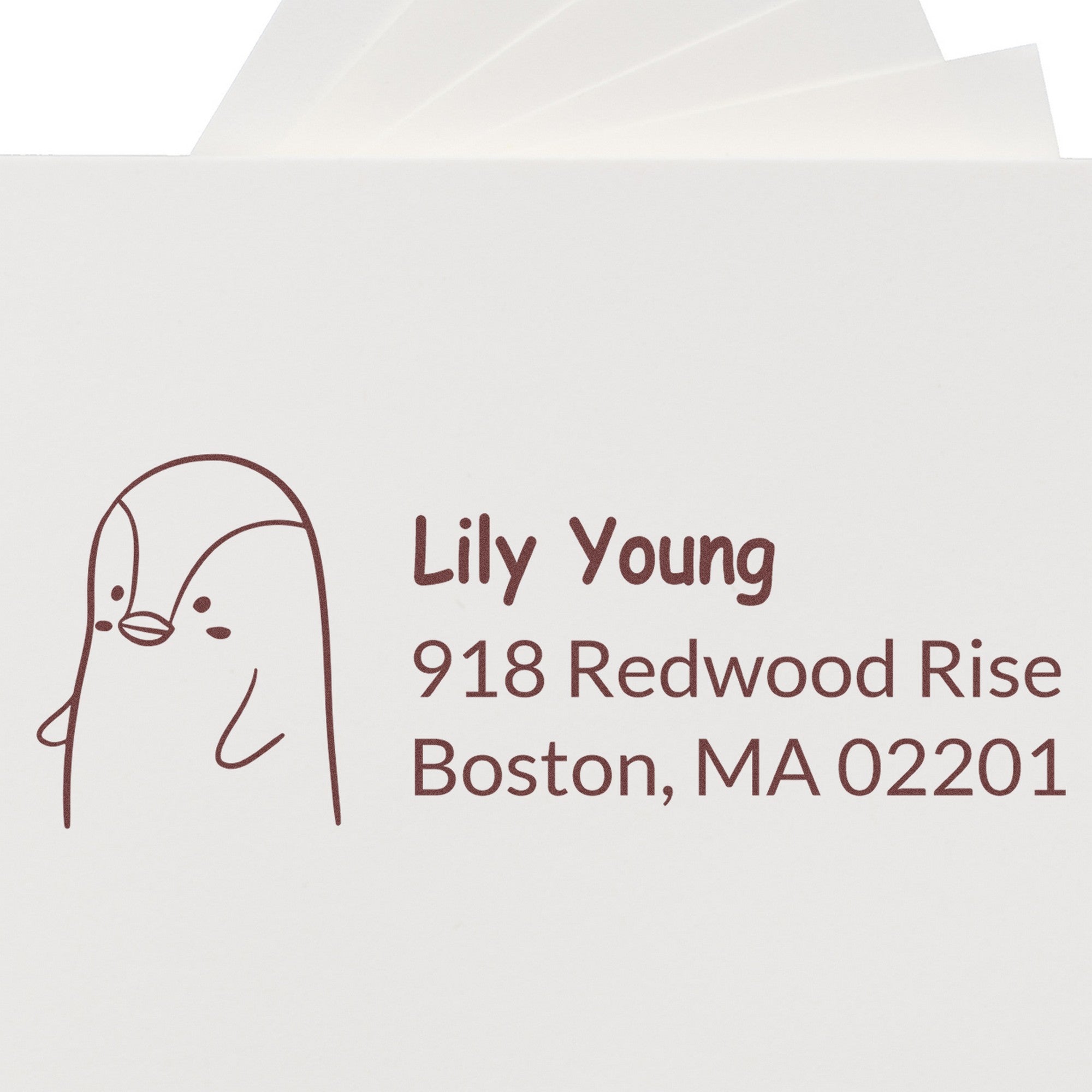 Wood Handle Perky Penguin Custom Mail Address Rubber Stamp on white paper, featuring a cute penguin illustration. Text reads "Lily Young, 918 Redwood Rise, Boston, MA 02201." Ideal for a Personalized New Address Stamp.