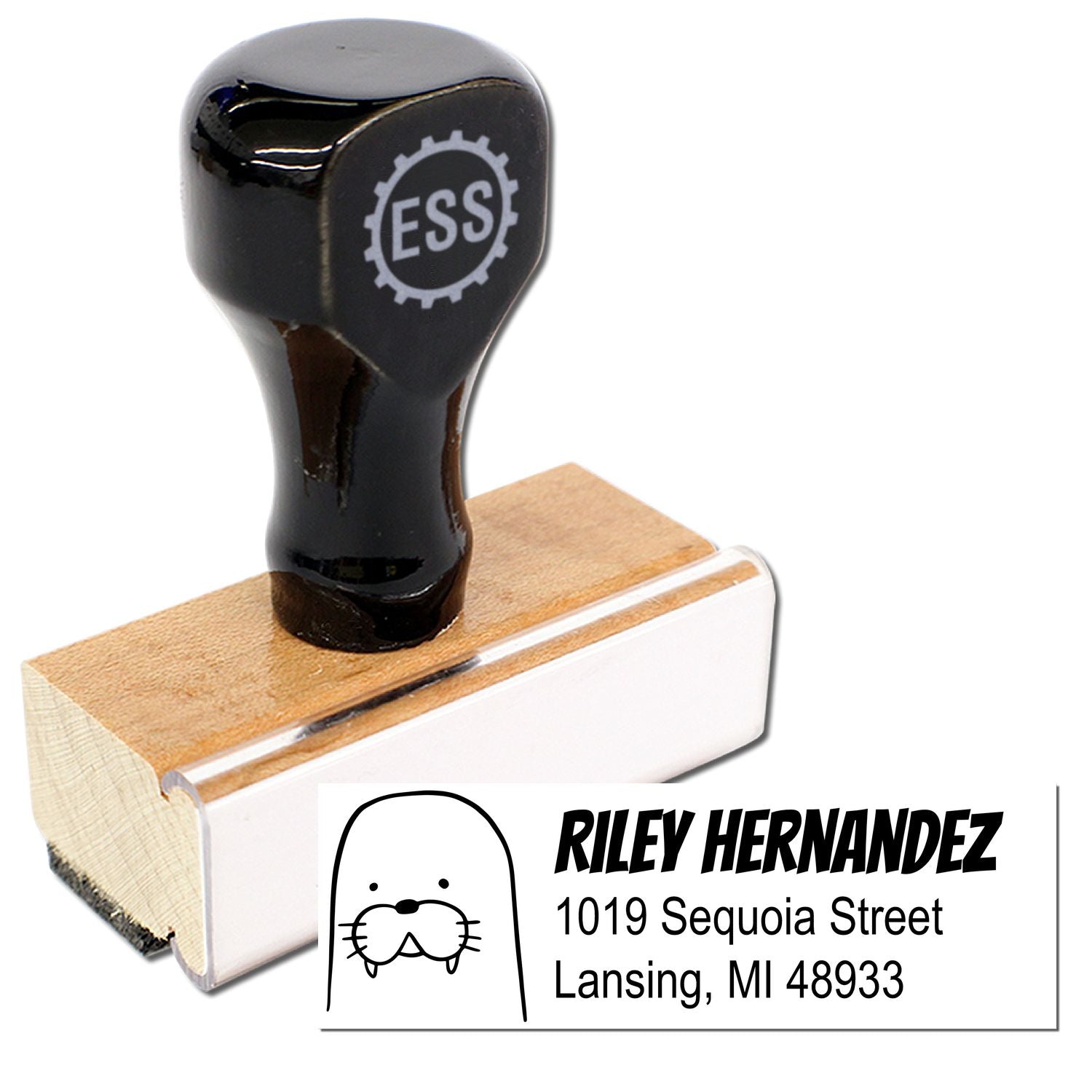 Wood Handle Wacky Walrus Custom New Address Rubber Stamp with a black top and wooden base. Features a personalizable home stamp design with a walrus graphic and sample address: Riley Hernandez, 1019 Sequoia Street, Lansing, MI 48933.