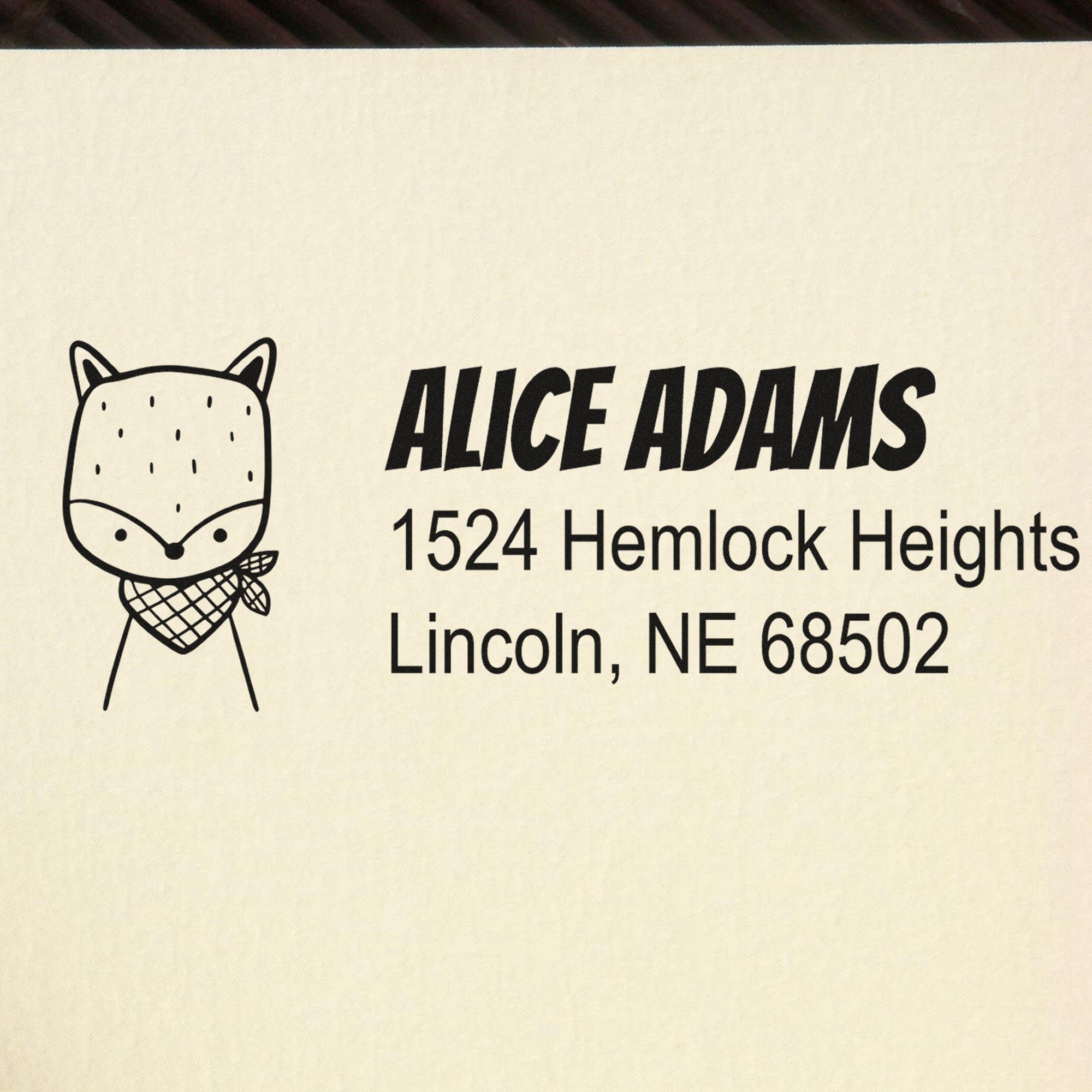 PSI Fancy Fox Customize Mail Address Pre-Inked Stamp featuring a cute fox design and bold text. Personalizable Return Mail Stamper displays "Alice Adams, 1524 Hemlock Heights, Lincoln, NE 68502" on a beige background.