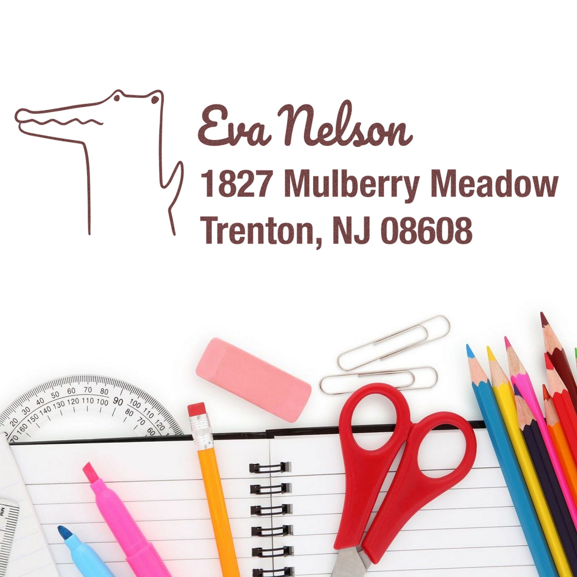 Wood Handle Charming Crocodile Customized Home Address Rubber Stamp displayed on paper with the name Eva Nelson and address. Surrounding items include pencils, scissors, and paper clips. Customizable Address Stamper ideal for personalizing stationery.