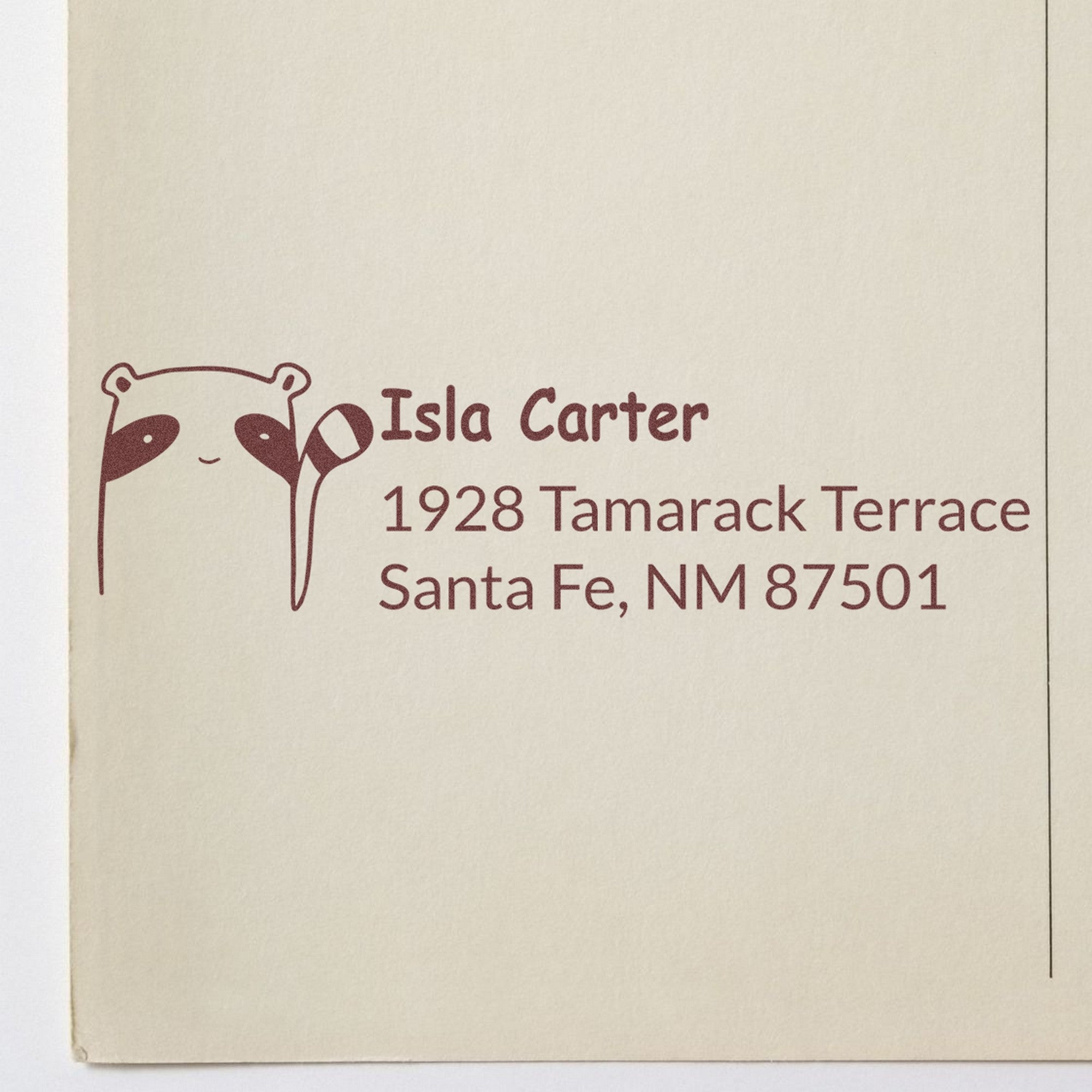 Wood Handle Renegade Racoon Customized Address Return Rubber Stamp on beige paper, featuring a raccoon graphic and text: "Isla Carter, 1928 Tamarack Terrace, Santa Fe, NM 87501." Ideal for a Custom New Address Stamp.
