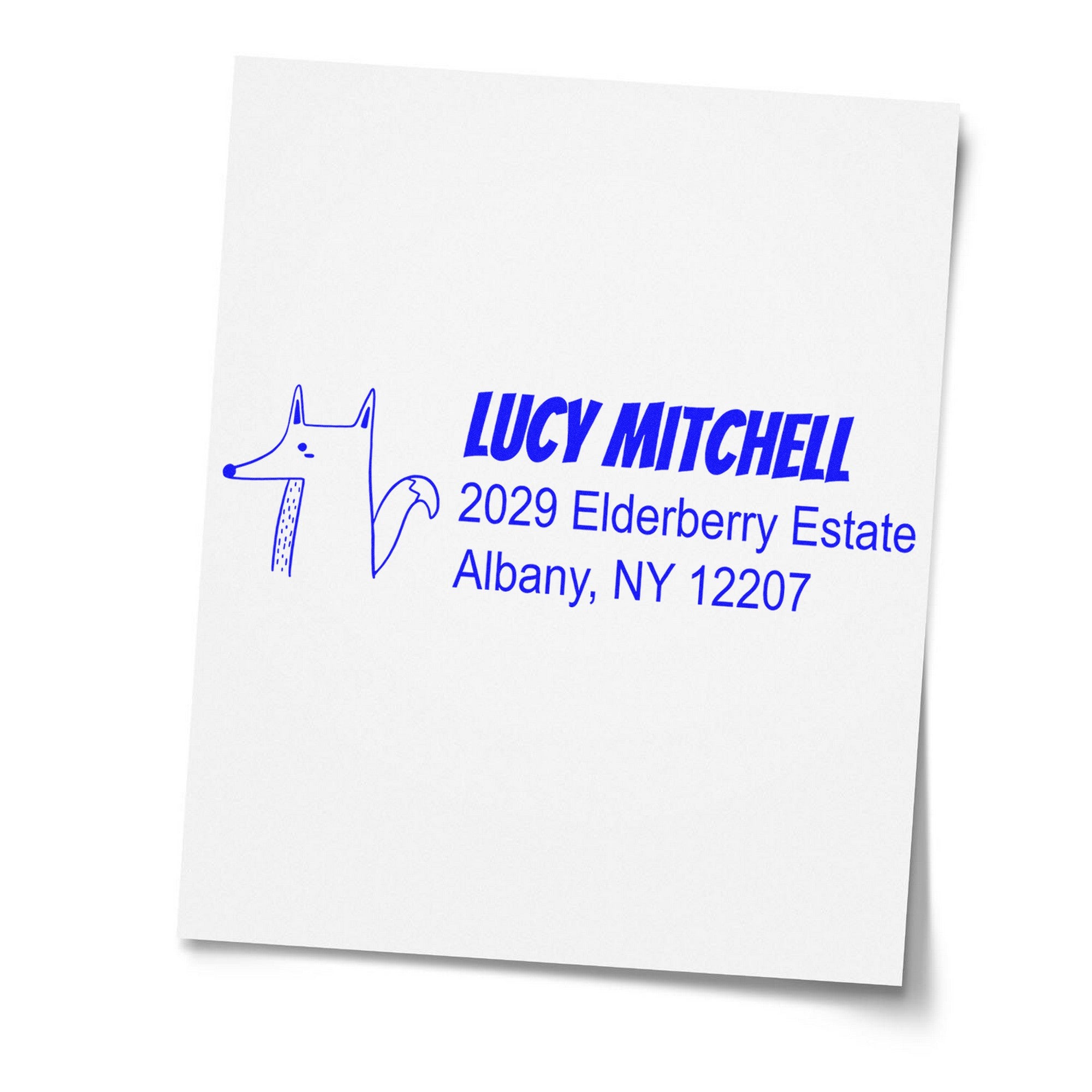 Wood Handle Finicky Fox Customized Mailing Address Rubber Stamp on white paper, featuring a fox illustration and blue text. Custom-Made Address Stamper displays "Lucy Mitchell, 2029 Elderberry Estate, Albany, NY 12207."
