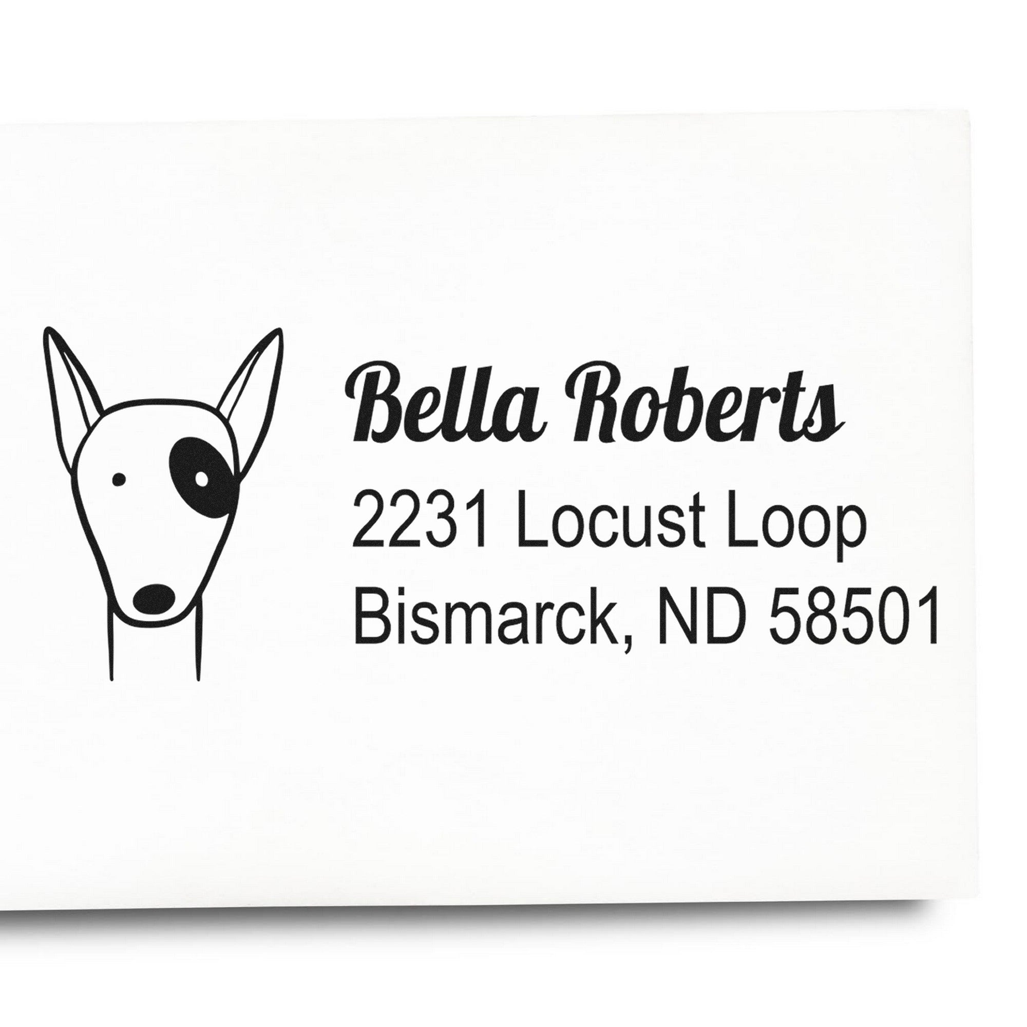 Wood Handle Perky Pooch Customized New Address Rubber Stamp featuring a dog illustration and text: "Bella Roberts, 2231 Locust Loop, Bismarck, ND 58501." This Custom-Made New Address Stamp is shown on white paper.