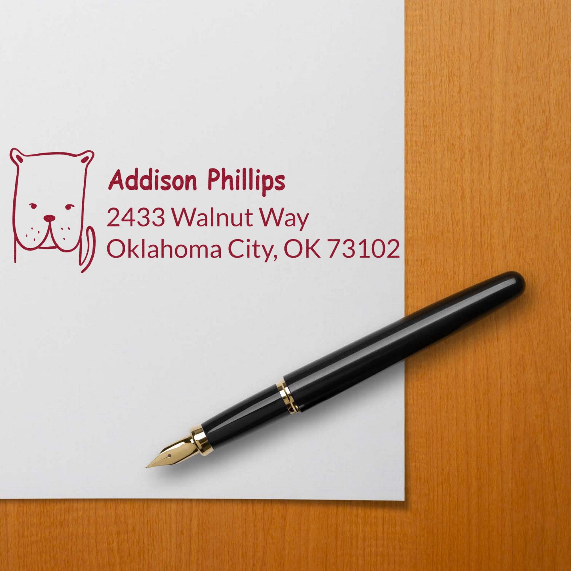 A PSI Daring Dog Customizable Home Address Pre-Inked Stamp is shown on a white envelope with a dog illustration and text reading Addison Phillips, 2433 Walnut Way, Oklahoma City, OK 73102. A black fountain pen lies nearby. Custom Return Mail Stamp.