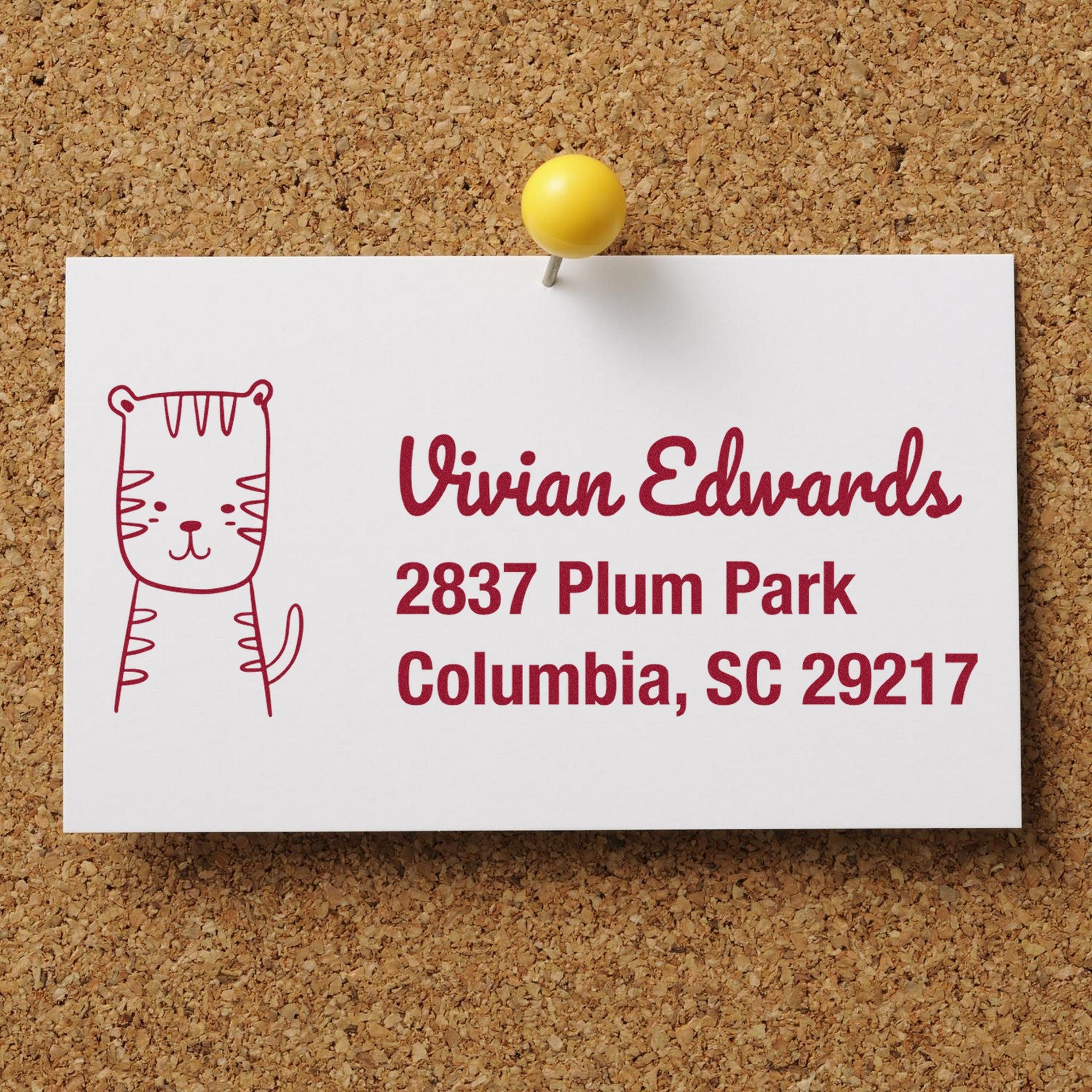 Wood Handle Terrific Tiger Handmade Mailing Rubber Stamp used on a card pinned to a corkboard. The card displays a cute tiger illustration and customizable new address stamper details: Vivian Edwards, 2837 Plum Park, Columbia, SC 29217.