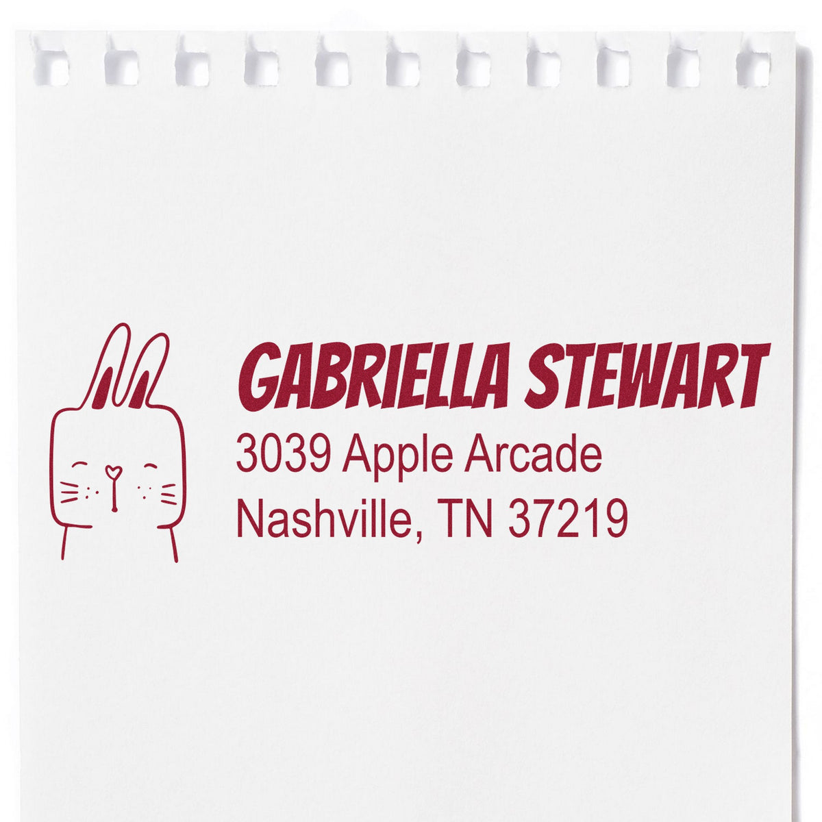 Slim Pre-Inked Fuzzy Rabbit Customize Name and Address Stamp on white paper, featuring a cute rabbit illustration. The Personalizable Home Stamper displays the name "Gabriella Stewart" with an address in red ink, showcasing its customization capability.