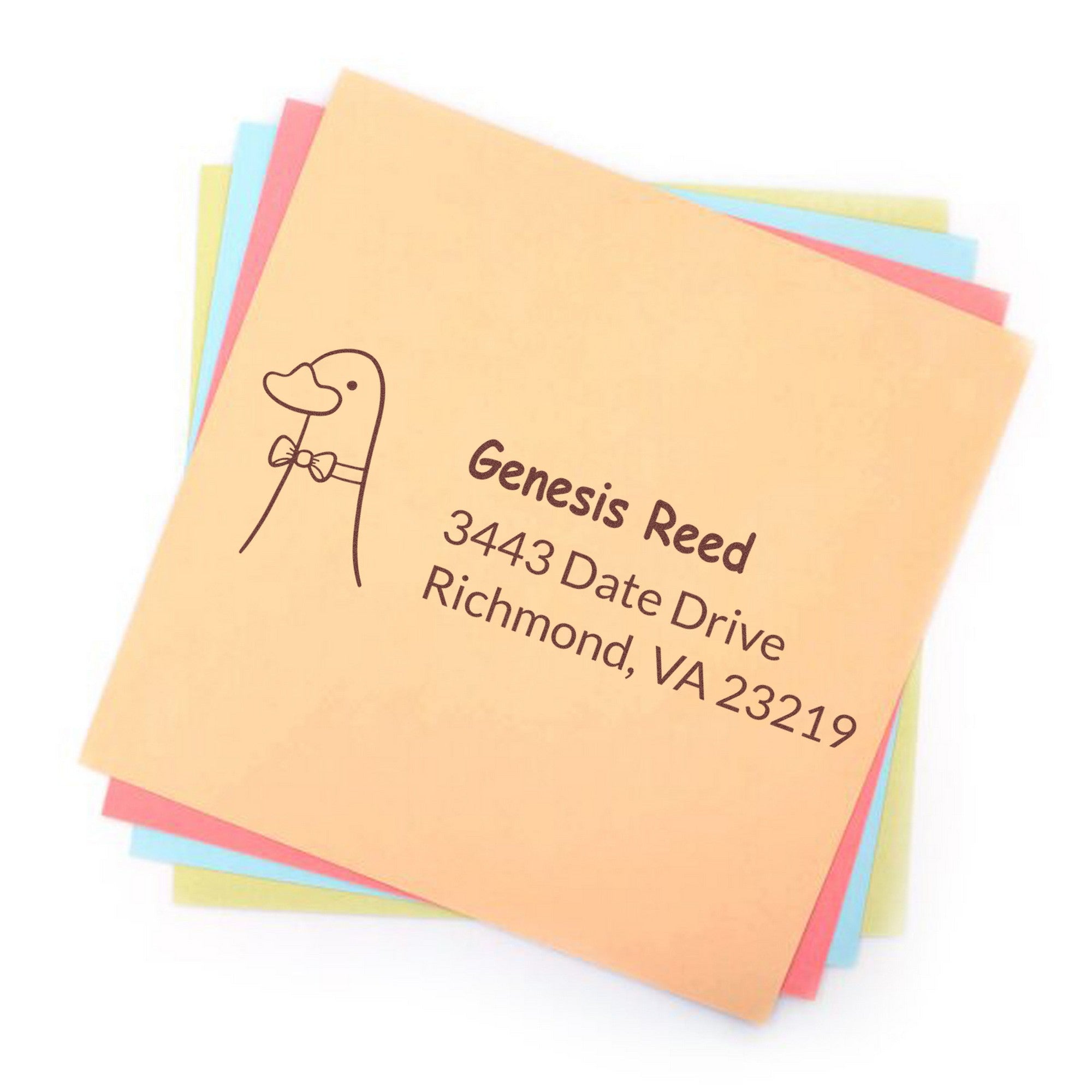 Dashing Duck Customized Address Self-Inking Stamp on a stack of colorful envelopes. The stamp features a duck illustration and text reading "Genesis Reed, 3443 Date Drive, Richmond, VA 23219." Ideal for a Customized Return Mail Stamp.