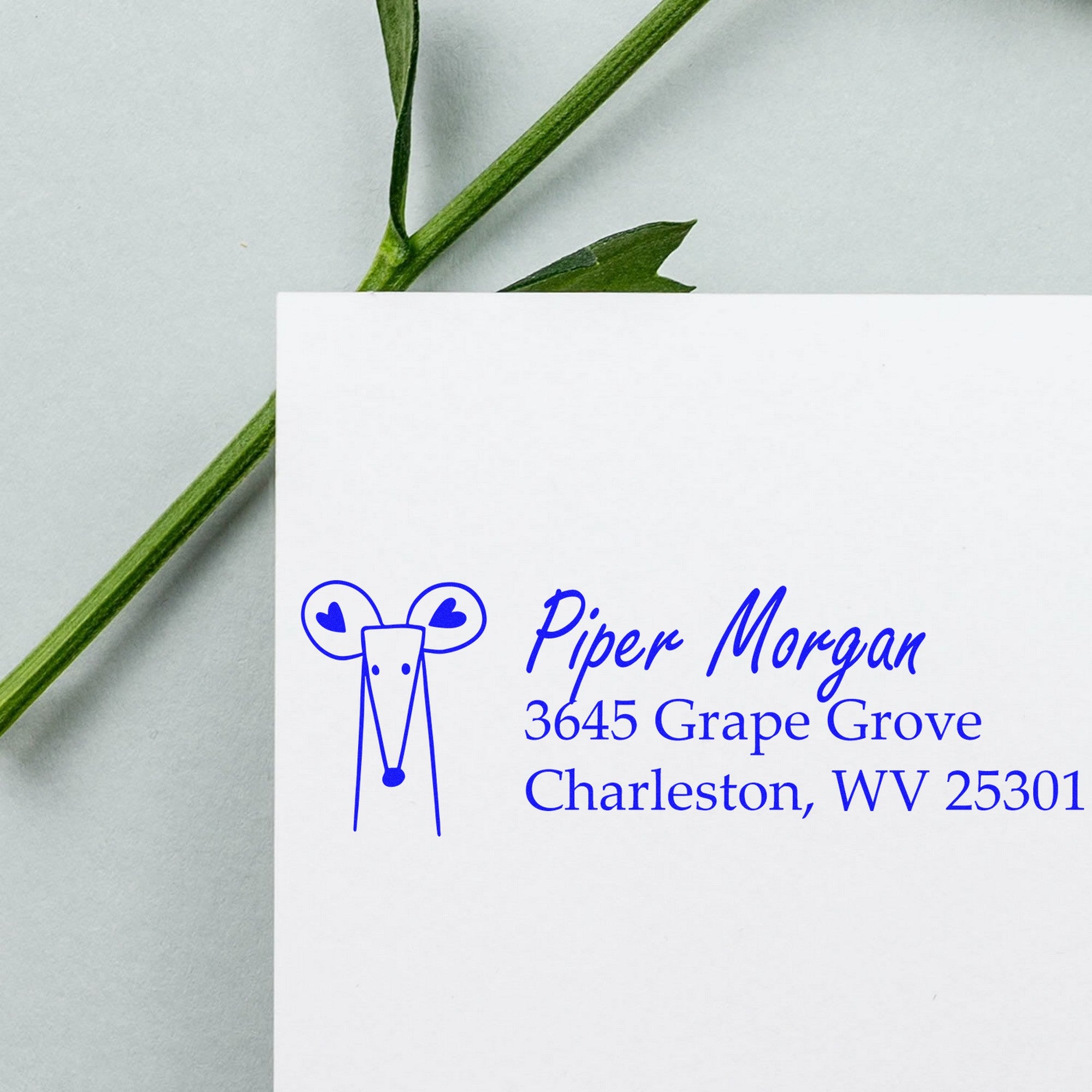 Wood Handle Mighty Mouse Handmade Address Label Rubber Stamp used on an envelope. The stamp features a mouse design with hearts and the text "Piper Morgan, 3645 Grape Grove, Charleston, WV 25301." Personalizable New Address Stamper shown on light background.