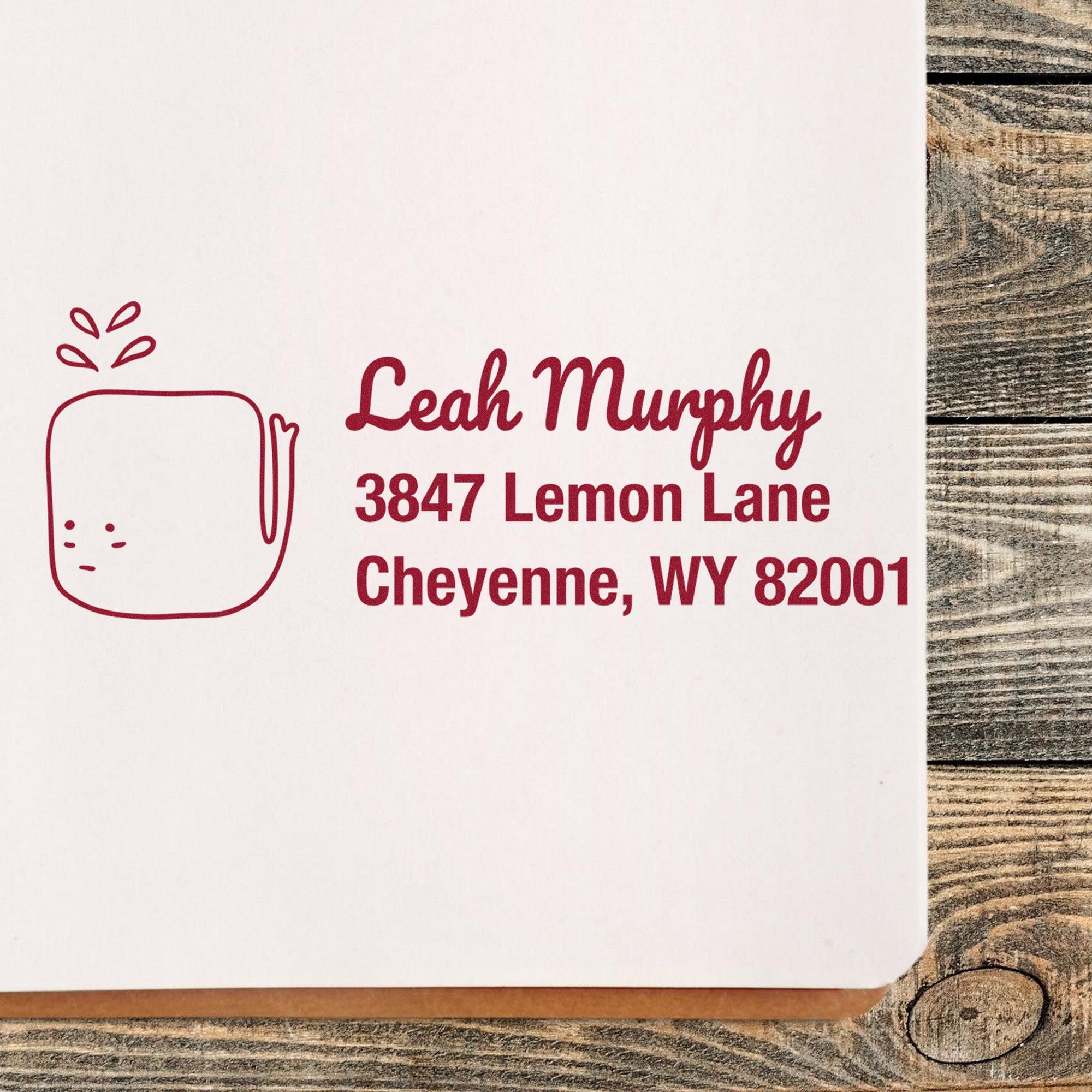 Wood Handle Joyful Whale Customize Return Address Rubber Stamp on a wooden surface. The stamp imprint shows "Leah Murphy, 3847 Lemon Lane, Cheyenne, WY 82001" with a whale design. Ideal for a custom-made home stamper.