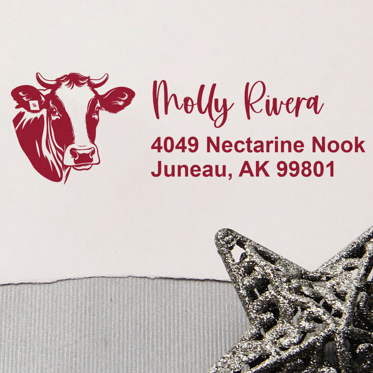 Red custom address stamp with cow logo, Molly Rivera address, and silver-black decorative seal on white background.
