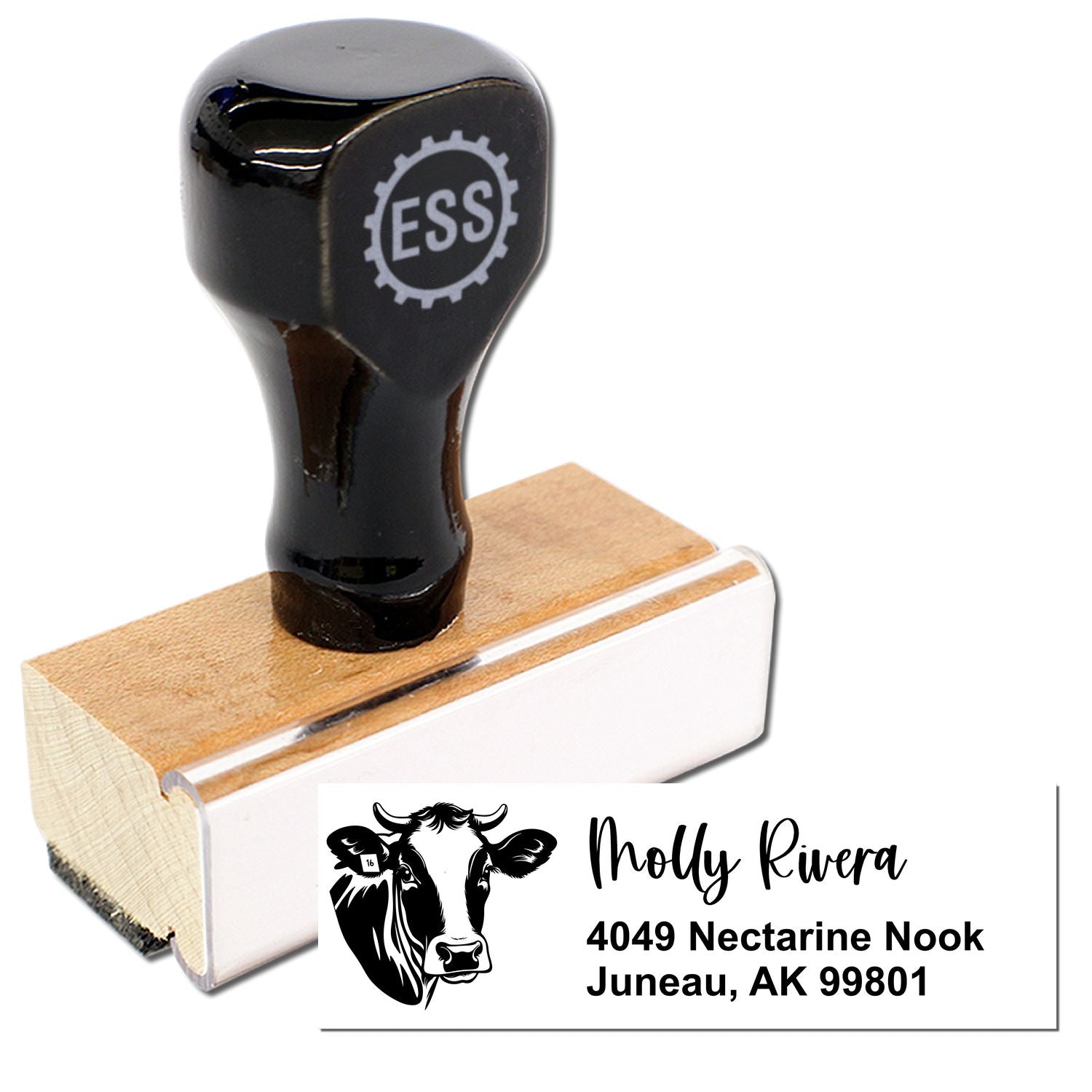 Black custom rubber stamp and seal with cow logo and white address imprint on wooden block.
