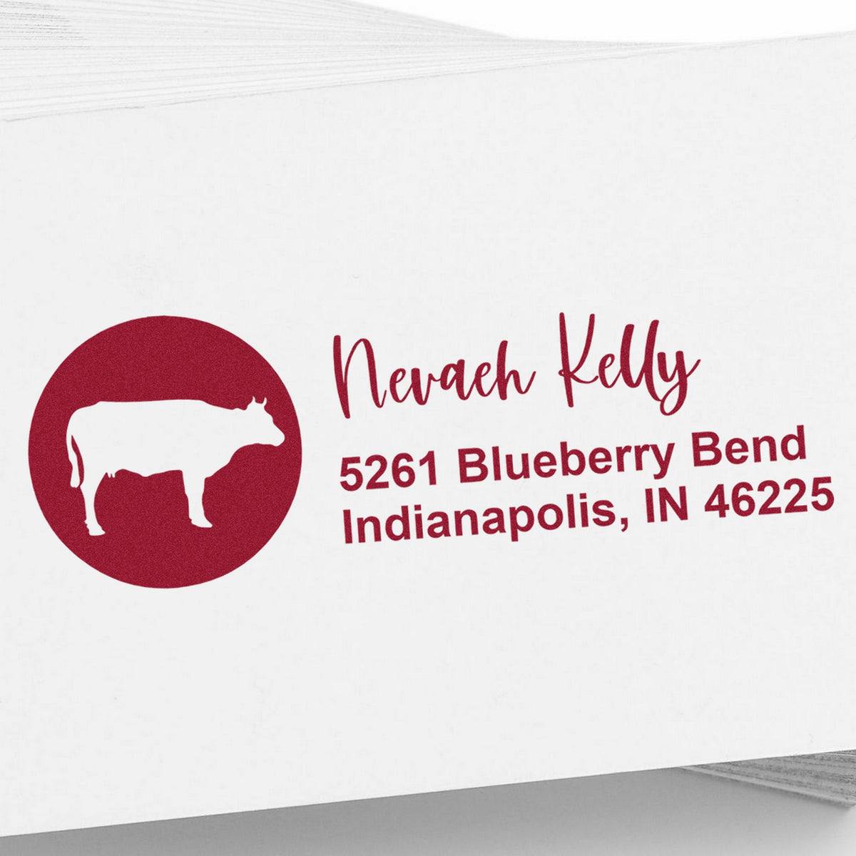 Deep red custom address stamp and seal with cow logo, Nevaeh Kelly, and Indianapolis address on white background.