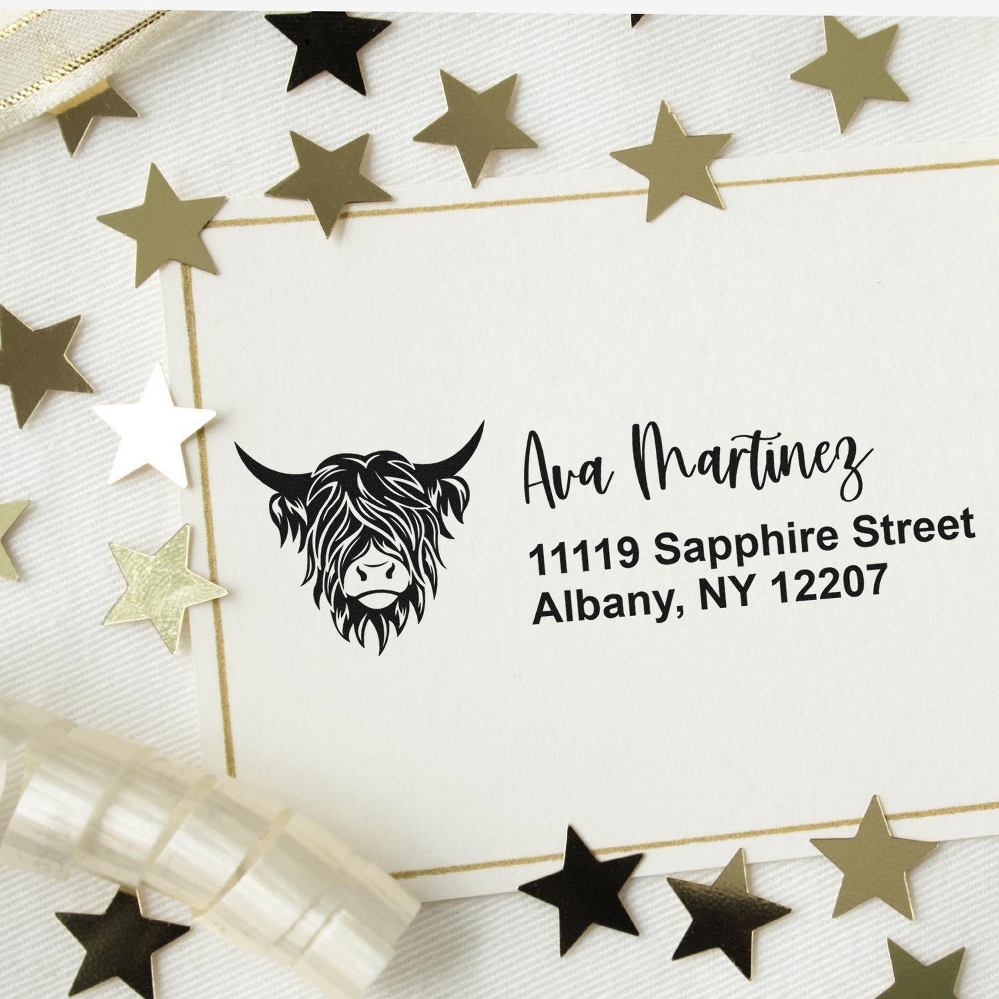 Custom address stamp and seal with buffalo head logo on white paper, bordered by gold and black stars.