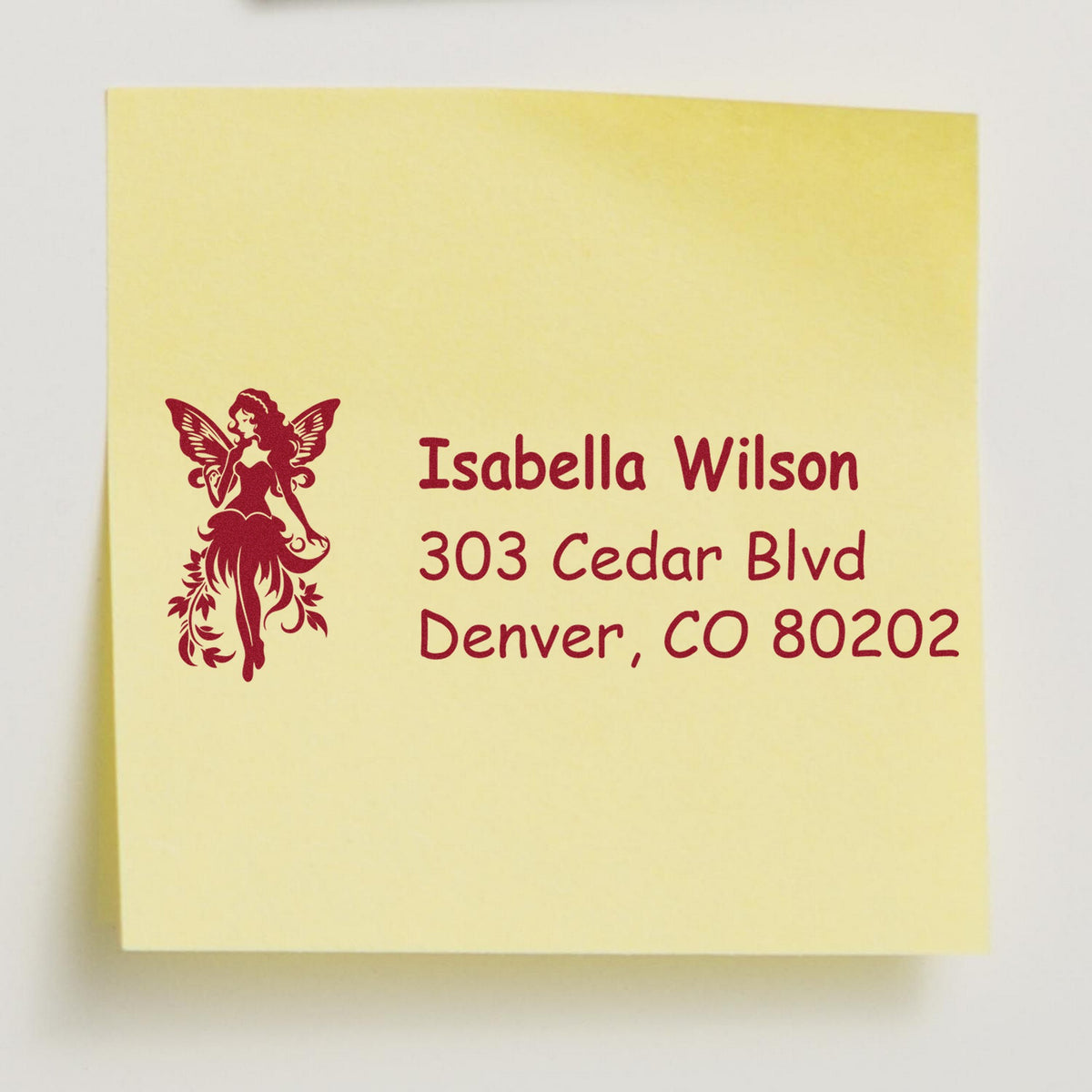 Yellow custom address stamp with burgundy fairy seal, showing Isabella Wilson and Denver, CO 80202.