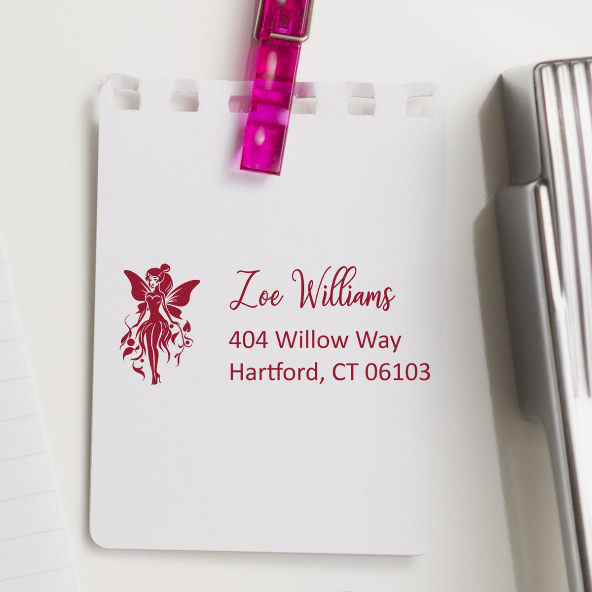 Pink translucent stamp and seal with burgundy fairy logo and personalized address on a white card