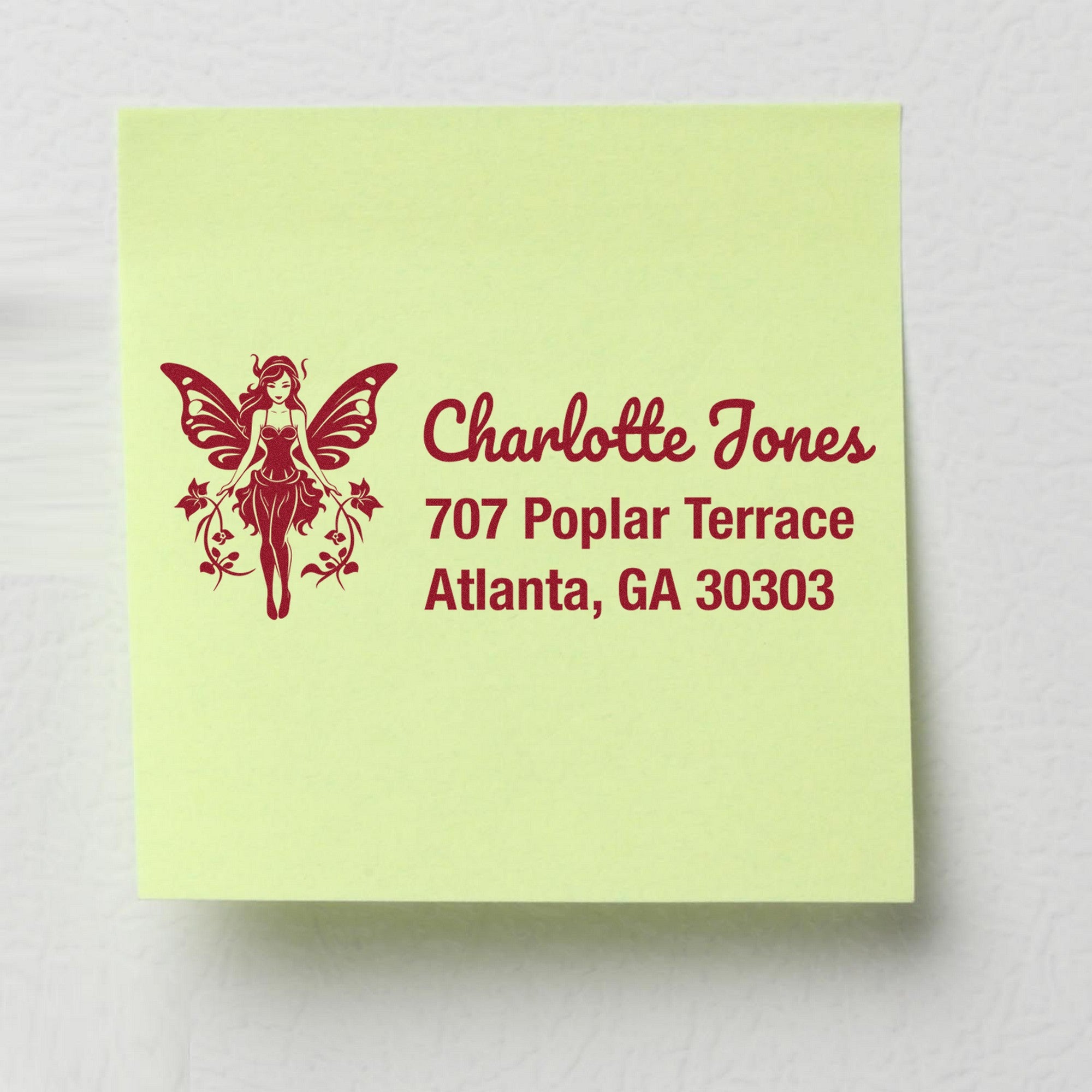 Custom maroon fairy address stamp on pale yellow-green paper with Charlotte Jones, 707 Poplar Terrace, Atlanta, GA 30303.