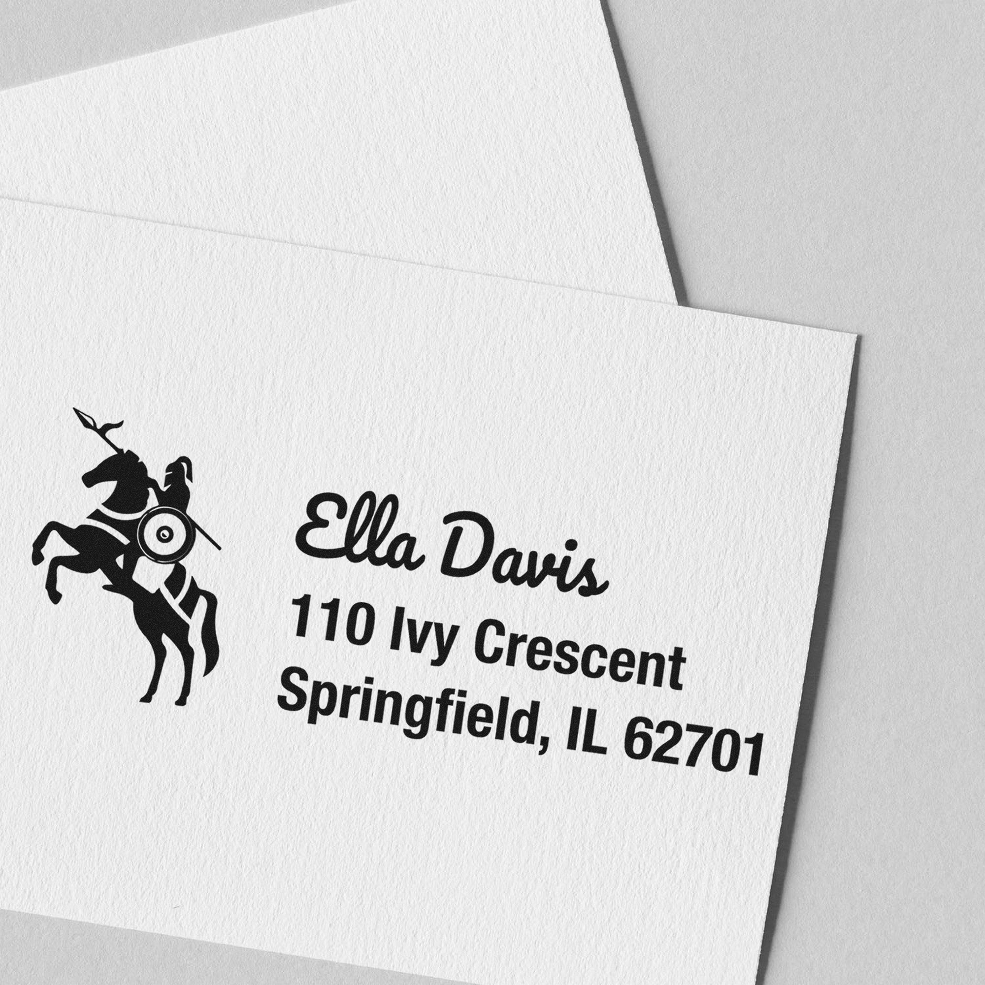Black business stamp and seal on white textured paper, featuring a horse rider logo and Ella Davis address.