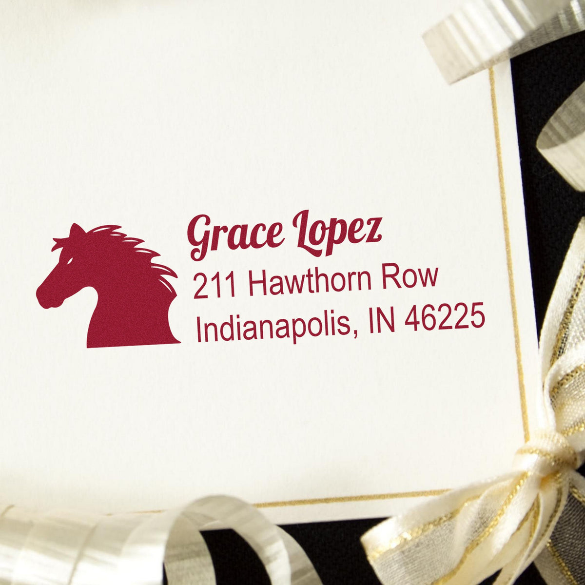 Burgundy horse-head custom address stamp with Grace Lopez, Indianapolis, and cream-gold ribbon seal accents.
