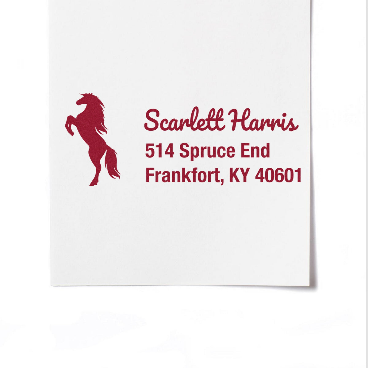 Custom burgundy horse silhouette address stamp with Scarlett Harris, 514 Spruce End, Frankfort, KY 40601 on white paper