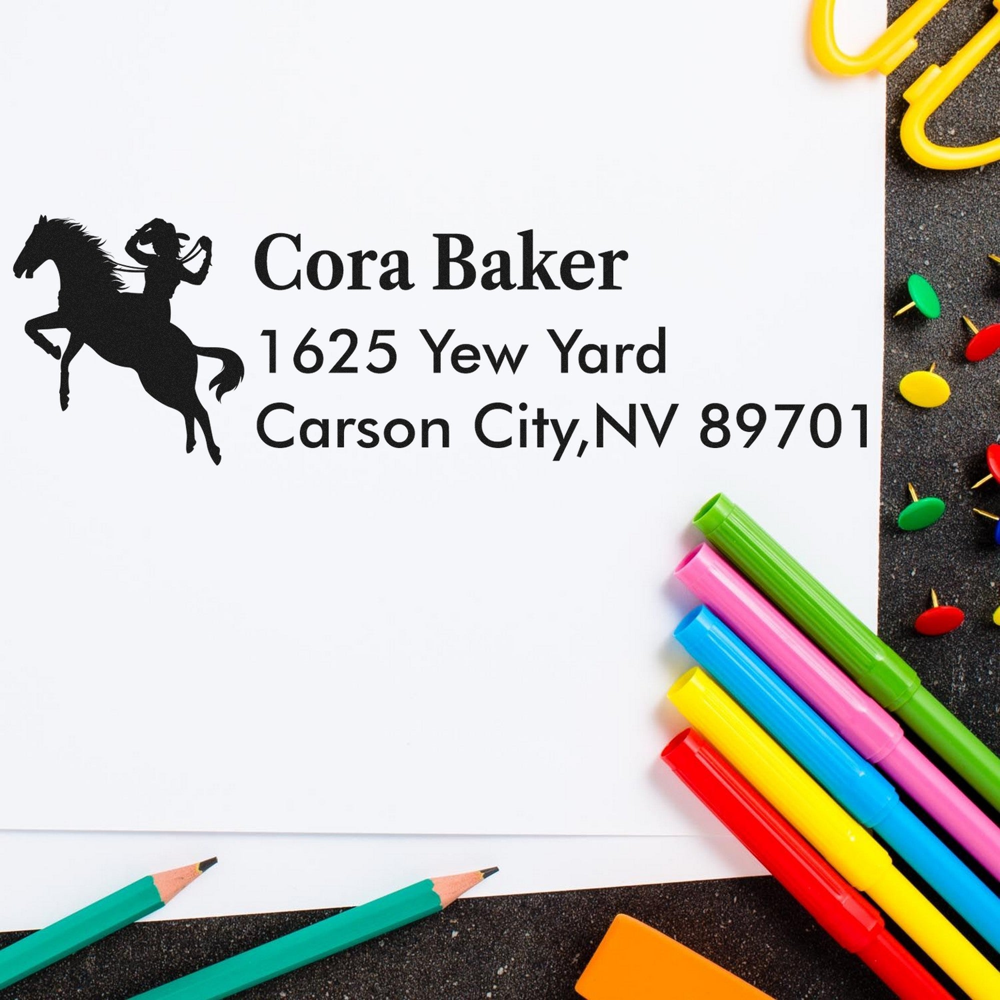 Custom address stamp and seal with horse rider logo, Cora Baker address, and colorful pens on white paper