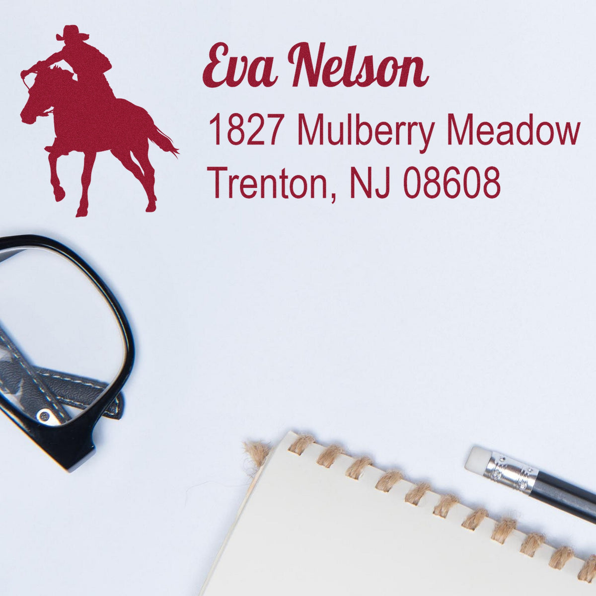 Red custom stamp and seal with horse-and-rider silhouette, Eva Nelson name, and Trenton, NJ address on white paper.