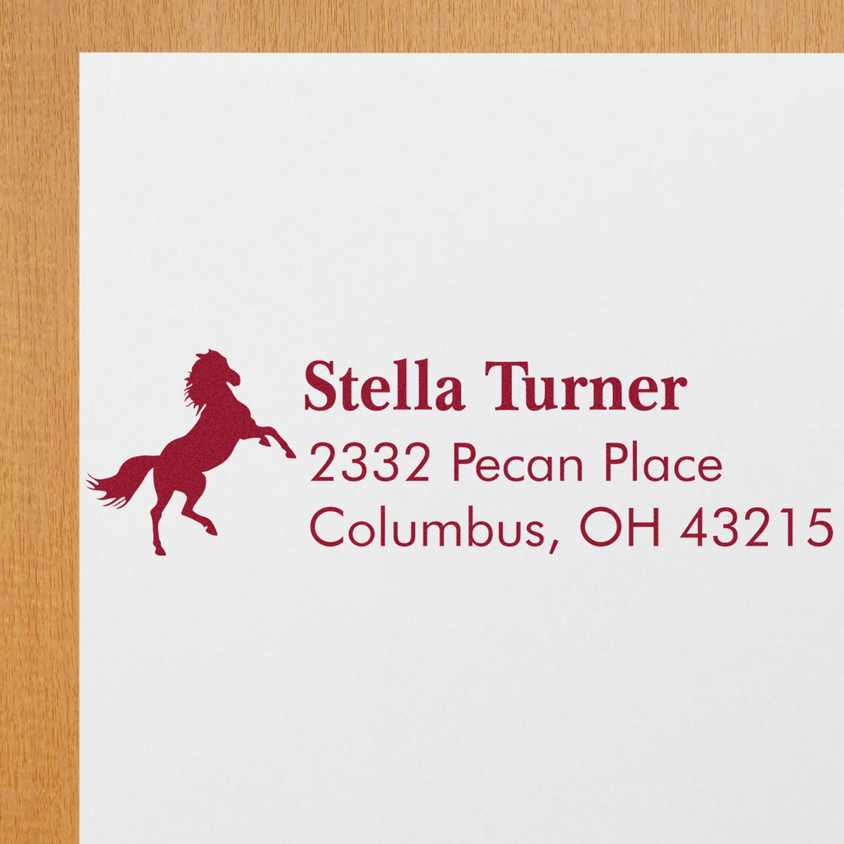 Maroon custom stamp and seal with horse silhouette, Stella Turner name, and Columbus, OH address on white paper.
