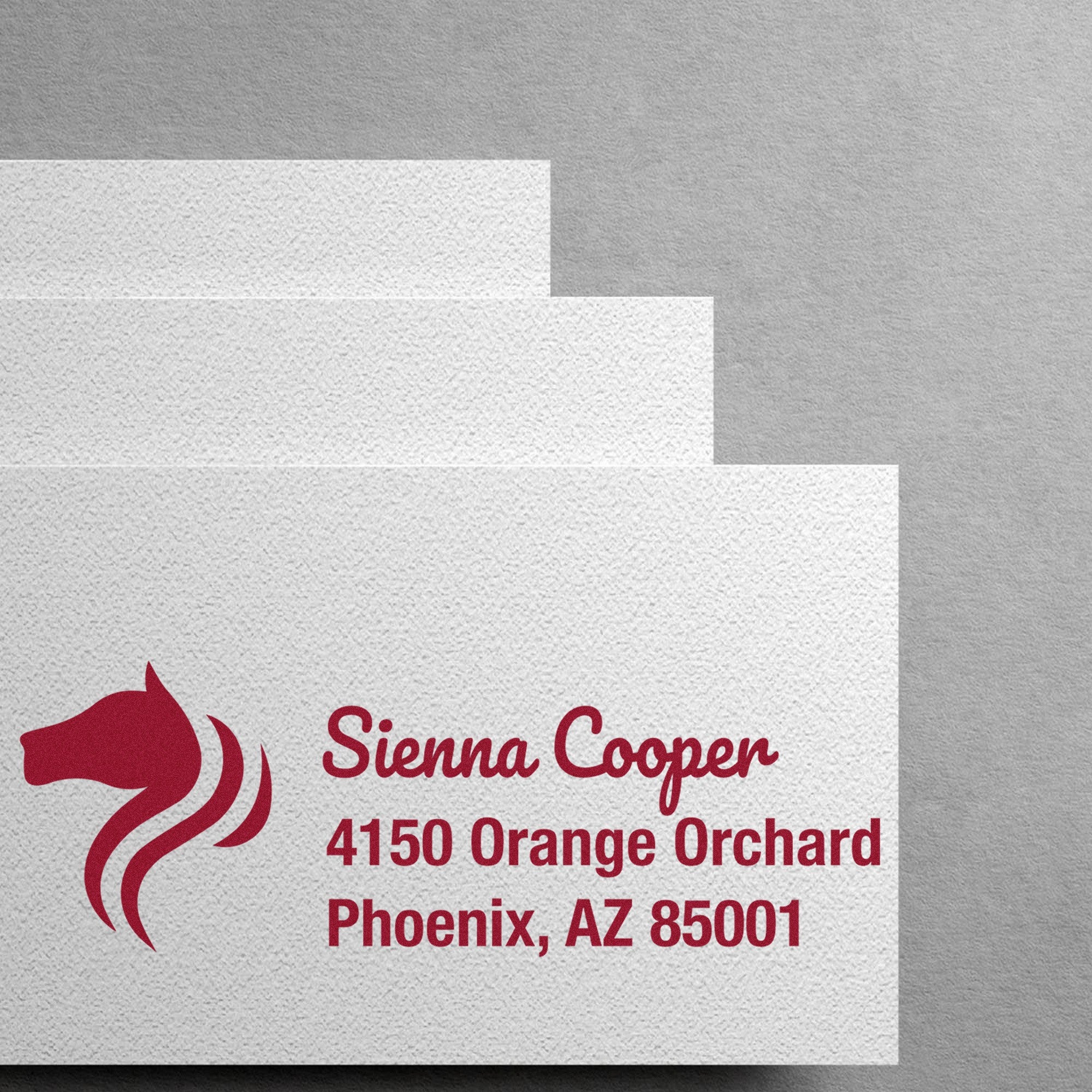 Textured gray and white stamp and seal samples with maroon Sienna Cooper logo and Phoenix, AZ address