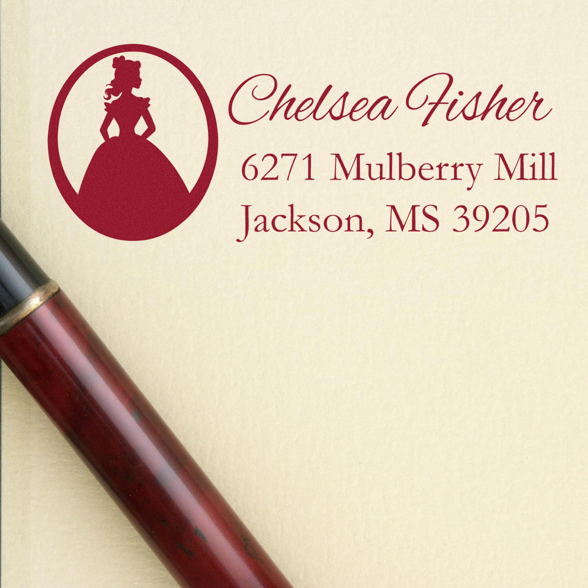 Burgundy custom wax seal stamp and seal with woman silhouette, Chelsea Fisher address, and red handle on cream paper.