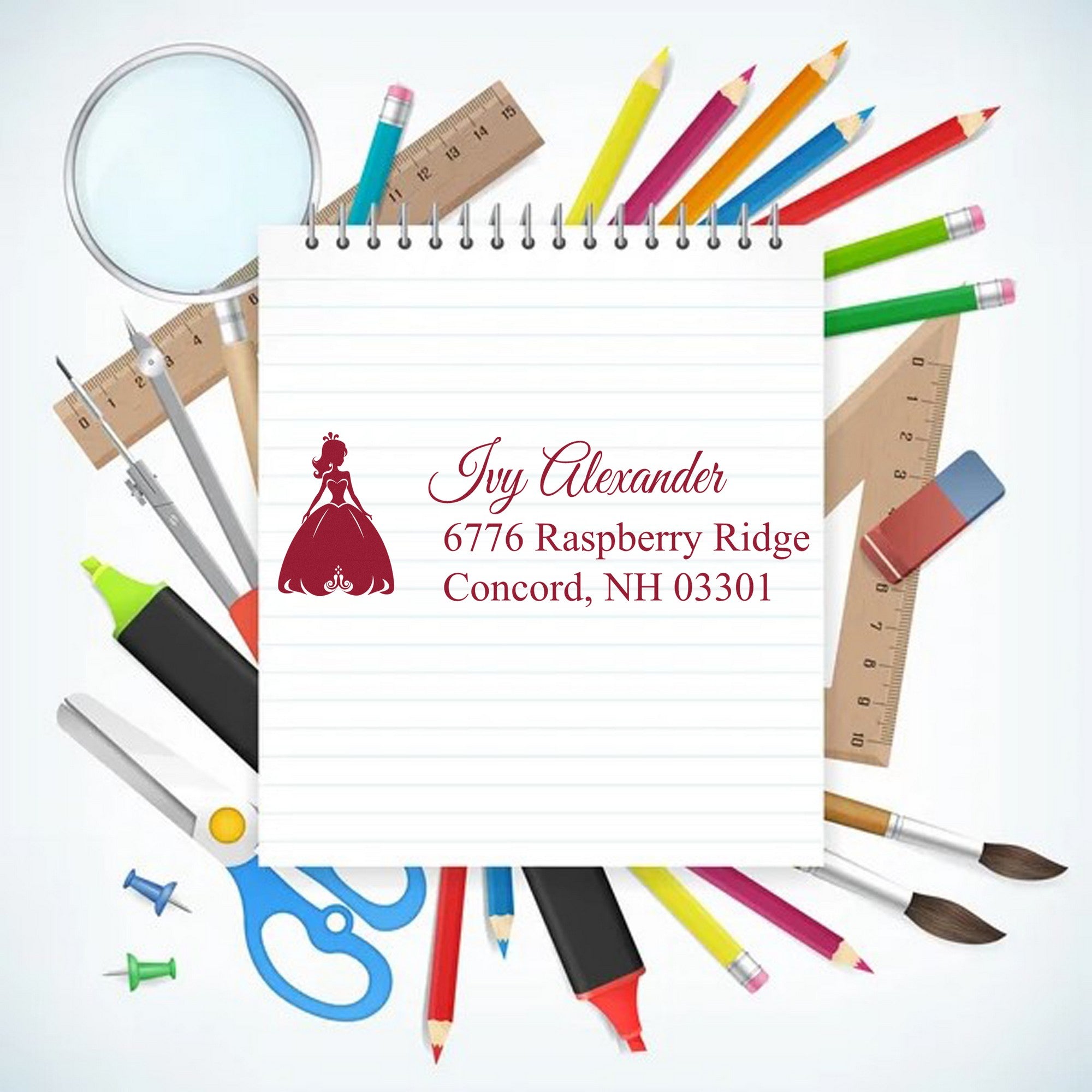Personalized stamp and seal on lined notepad with maroon princess logo, surrounded by colorful pencils, rulers, scissors and art tools.