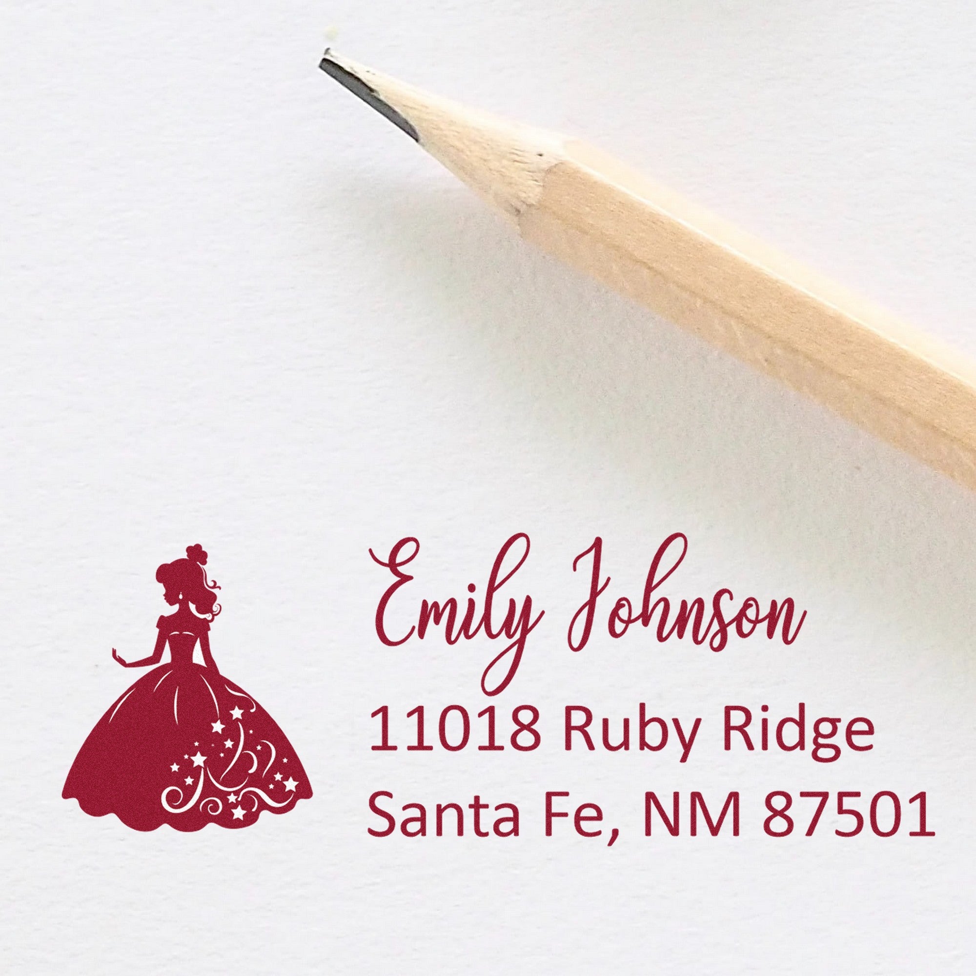 Burgundy personalized address stamp with princess silhouette, Emily Johnson, Santa Fe NM 87501 on white envelope.