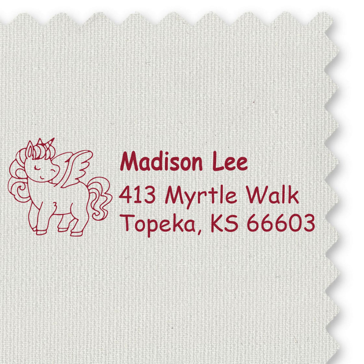 Burgundy custom address stamp and unicorn seal on off-white fabric swatch, Madison Lee, Topeka KS 66603