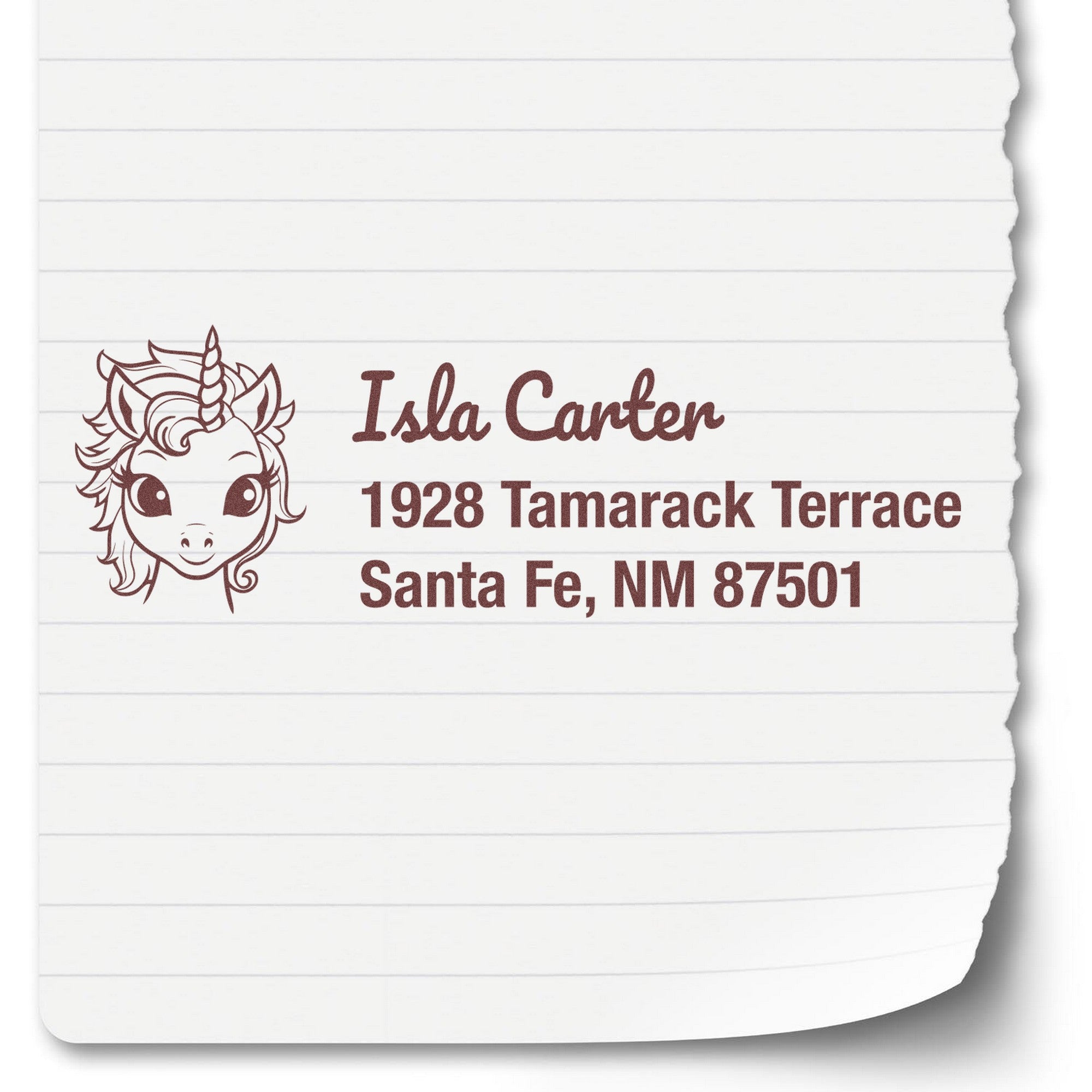 Brown custom address stamp with unicorn seal design on white paper, showing name, street address, and Santa Fe, NM 87501