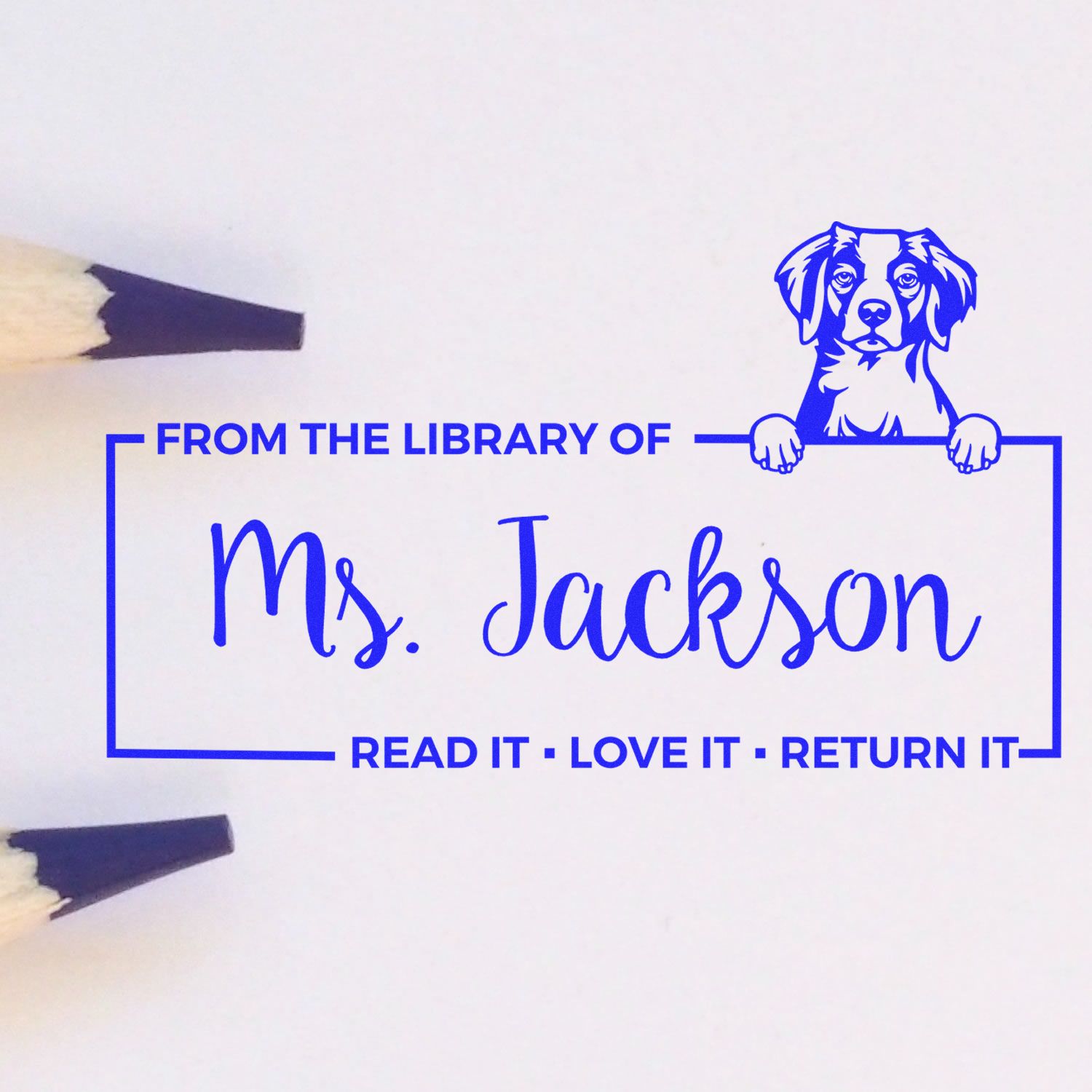 Blue custom library stamp and seal with dog icon, reading From the Library of Ms. Jackson and Read it, Love it, Return it.