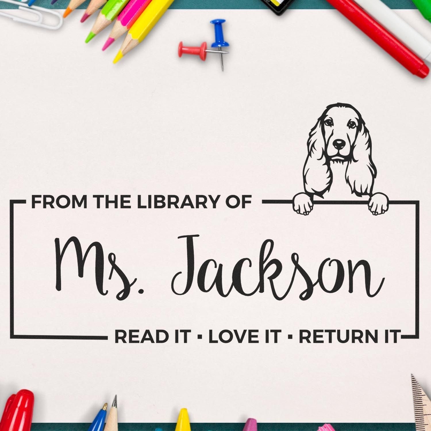Custom black library stamp seal for Ms. Jackson with dog illustration, surrounded by colorful pencils and push pins.