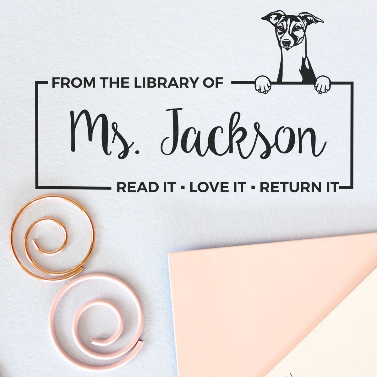 Black library stamp for Ms. Jackson with dog seal, on white paper; copper and pink sealing wax coils and folded pastel card.
