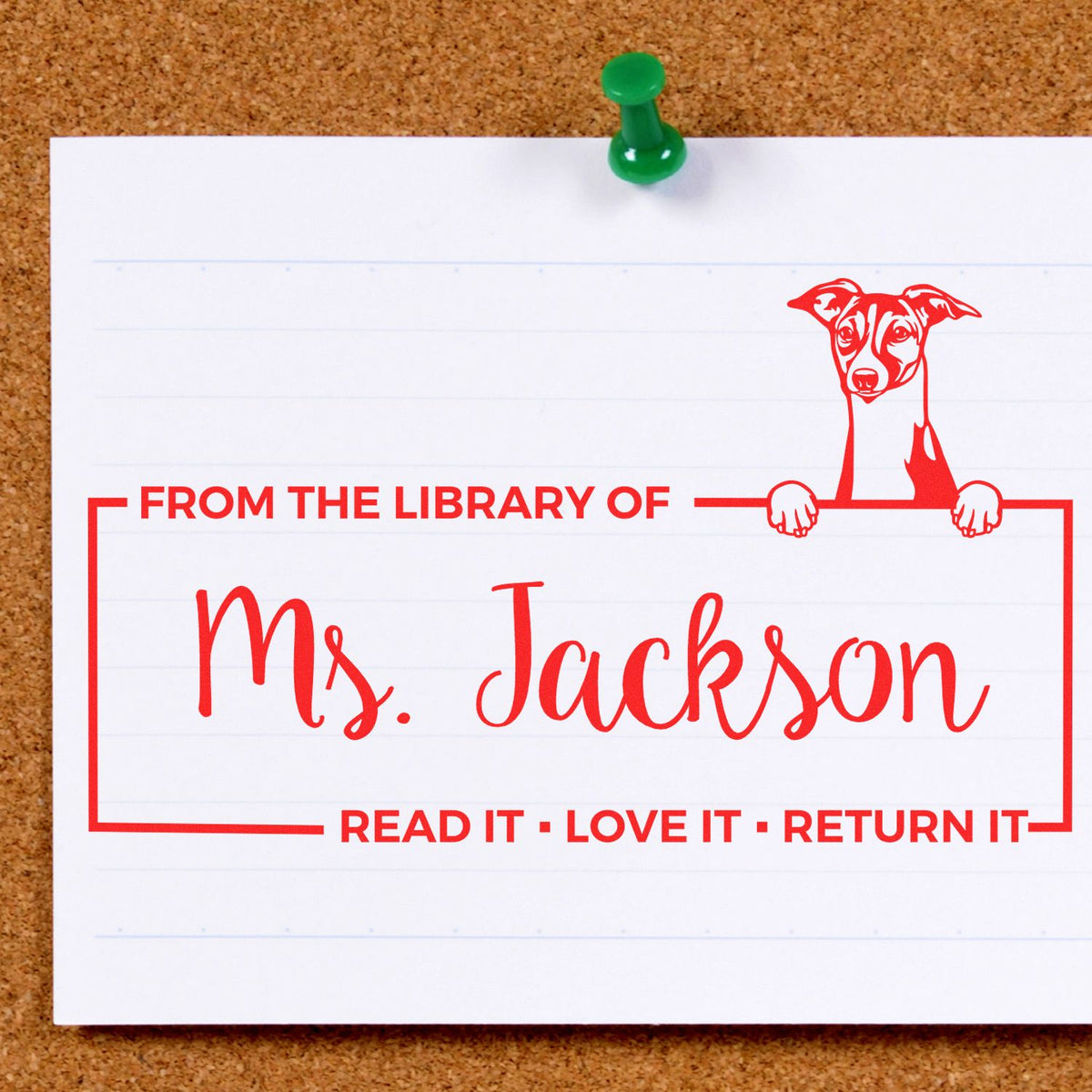 Red custom library stamp and seal with dog illustration and Ms. Jackson text on white card, pinned to corkboard with green pushpin.