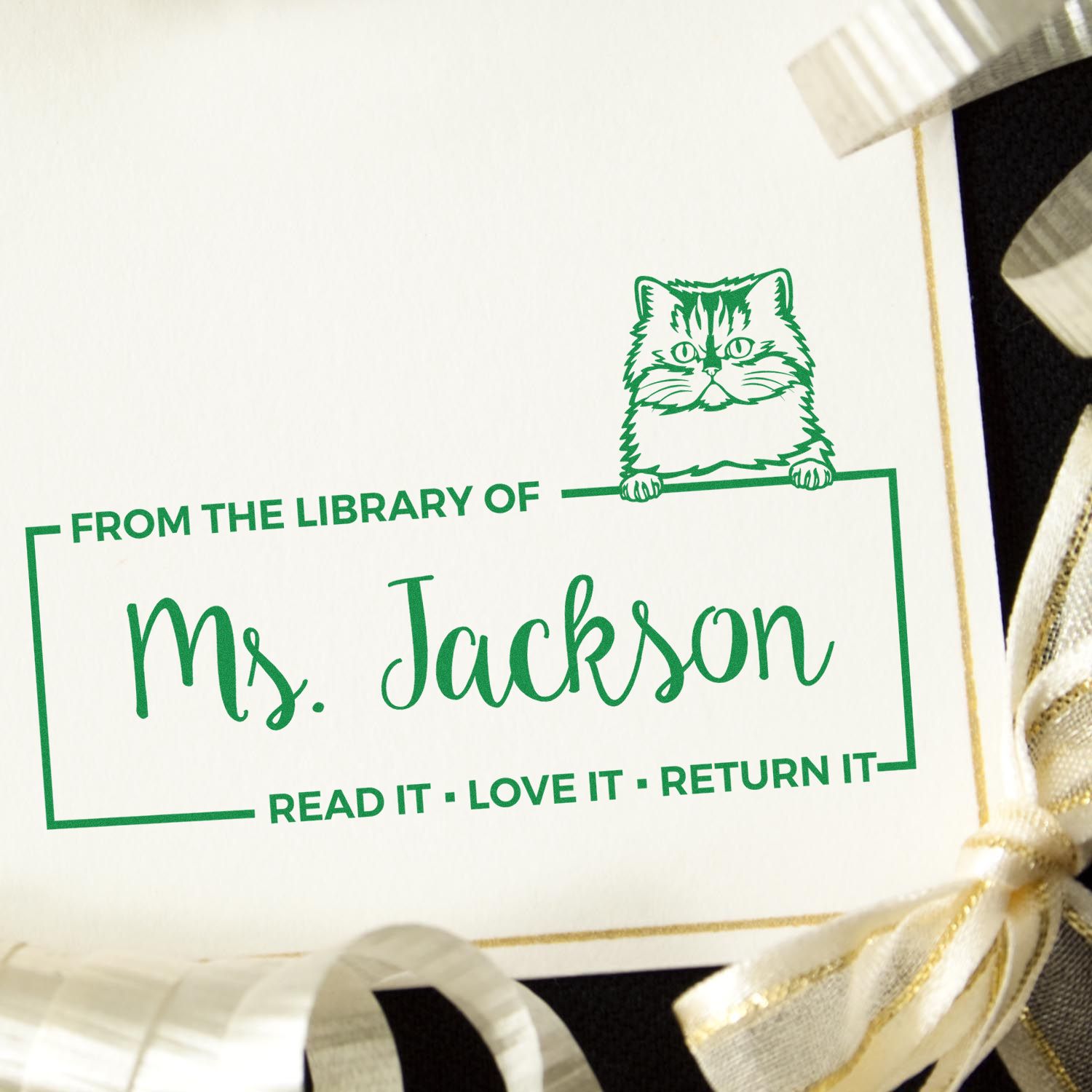 Green custom library stamp and seal with cat graphic, ĀMs. Jackson,Ā and slogan ĀRead it Ā· Love it Ā· Return it.Ā