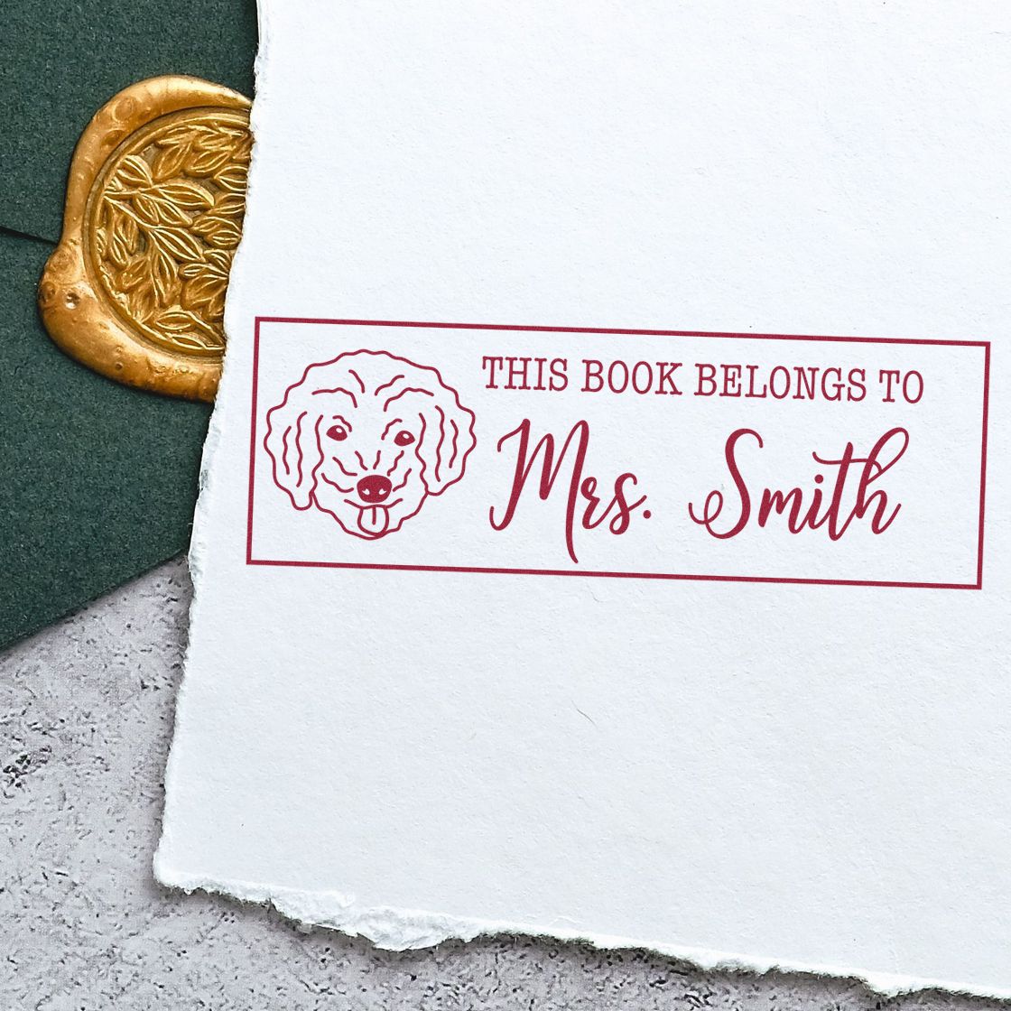 Red custom book stamp reading This Book Belongs to Mrs. Smith with dog illustration beside a gold embossed wax seal.
