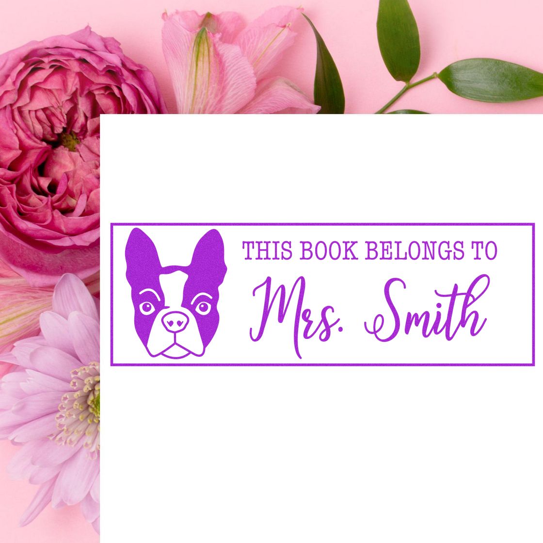 Purple custom book ownership stamp and seal with dog icon, This Book Belongs to Mrs. Smith, on a pink floral background.