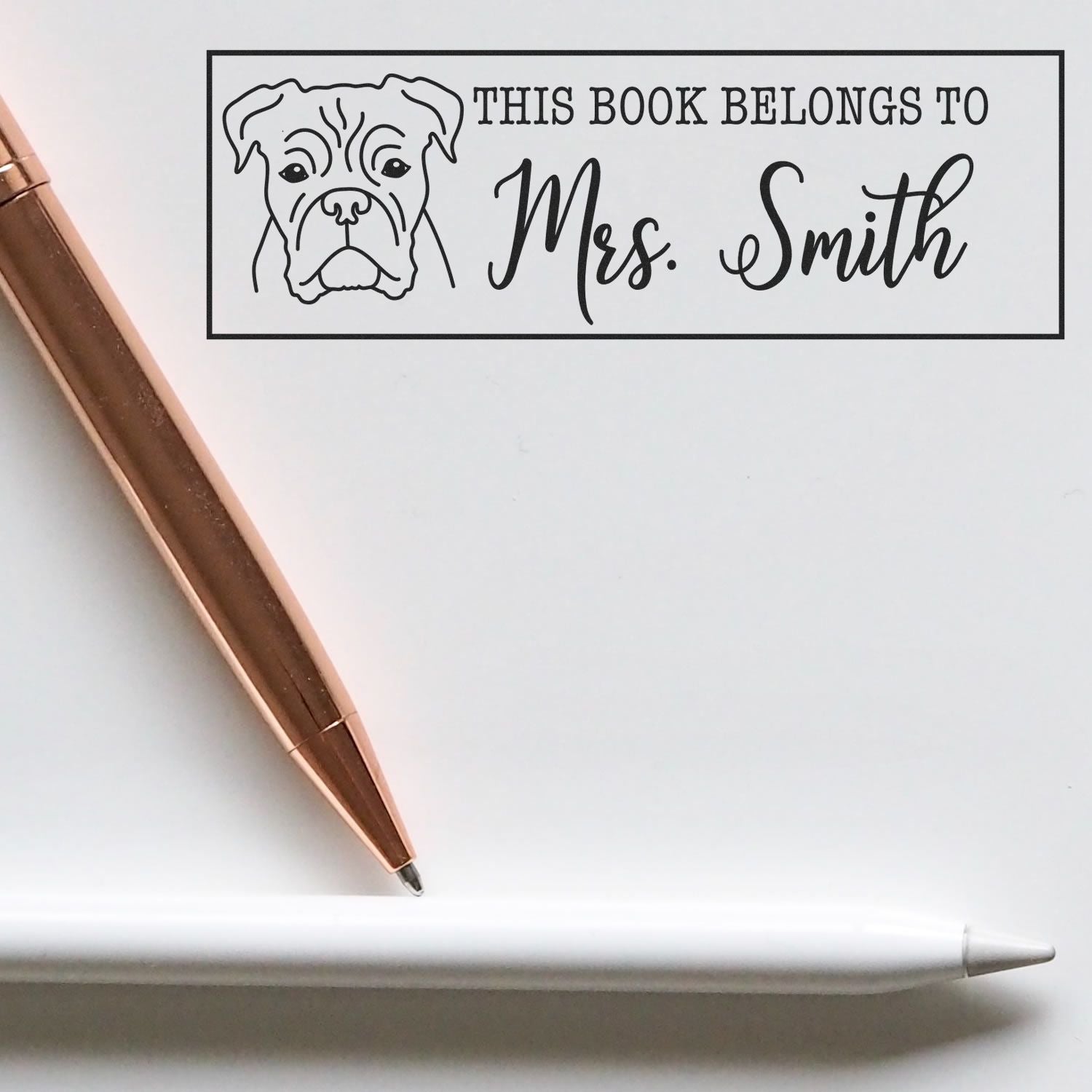 ESS Wood Handle Boxer Dog Rubber Stamp in use, featuring detailed boxer illustration on a wooden handle for book identification.