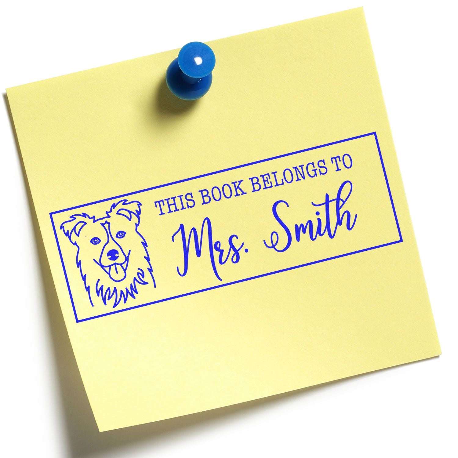 Yellow sticky note with blue pushpin and blue custom book stamp reading This book belongs to Mrs. Smith with dog icon.