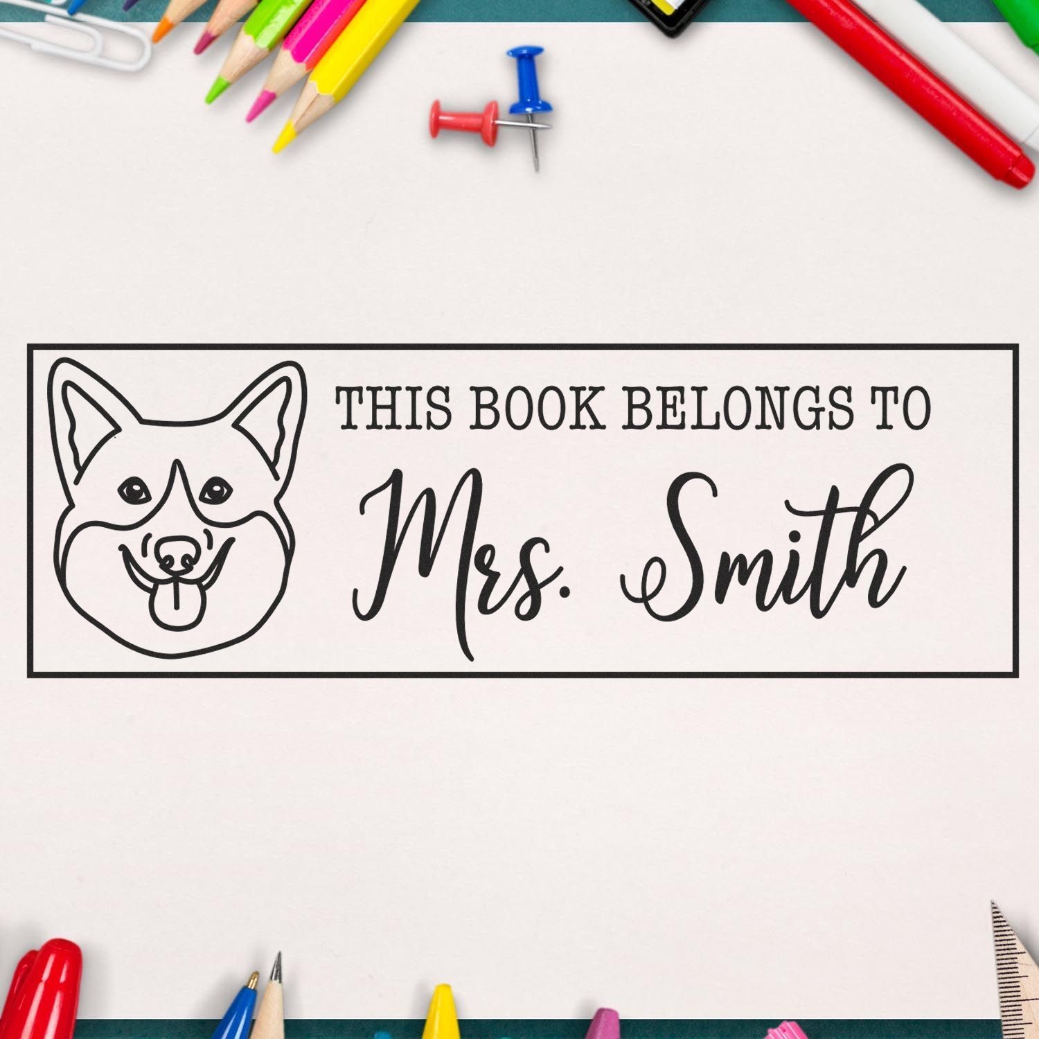Personalized black-and-white book stamp seal for Mrs. Smith with dog outline, surrounded by colorful pencils and push pins.