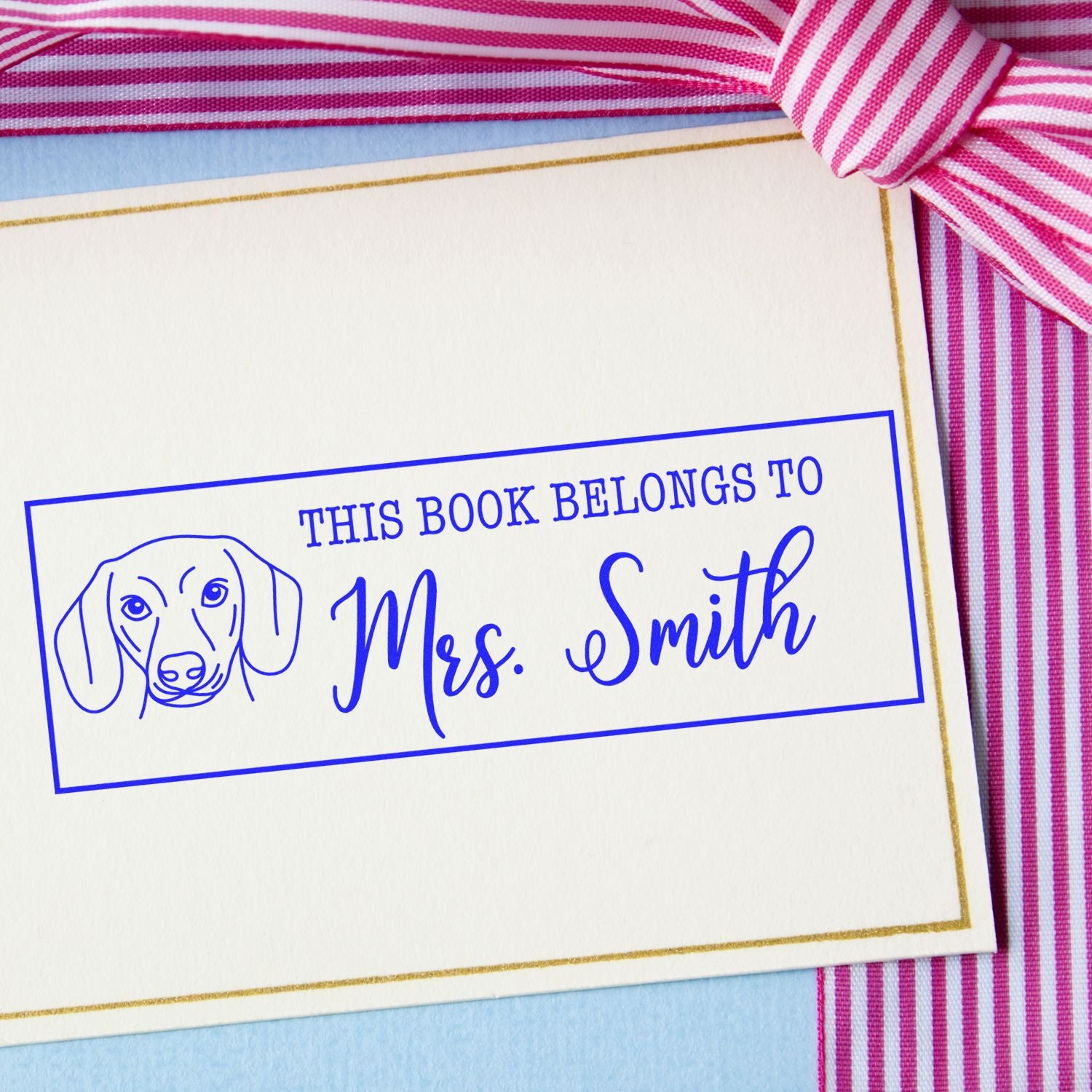 ESS Wood Handle Dachshund Rubber Stamp featuring a personalized "belongs to" design, in use on a paper surface.