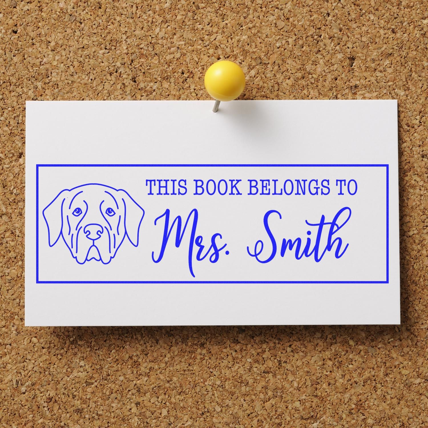Blue dog bookplate stamp reading This Book Belongs to Mrs. Smith on white card, pinned with yellow pushpin.